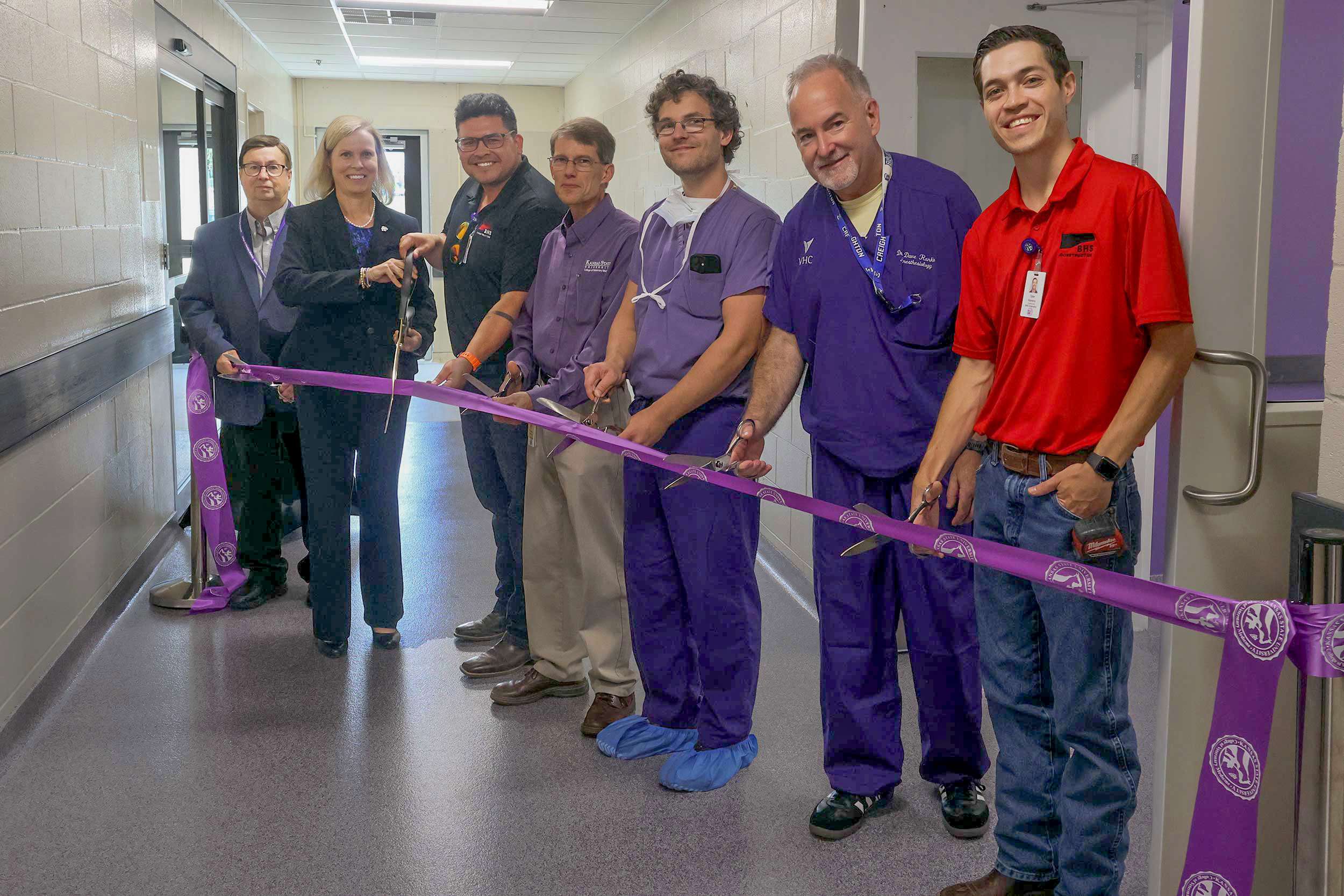 IPs with the K-State College of Veterinary Medicine and BHS Construction cut the ribbon for the newly expanded small animal surgery center. From left: James Roush, Elizabeth Davis, both from K-State; A.J. Devlin, BHS; Walter Renberg, Nathaniel Kapaldo, David Rankin, all from K-State; and Tyler Havens, BHS. Courtesy of KSU