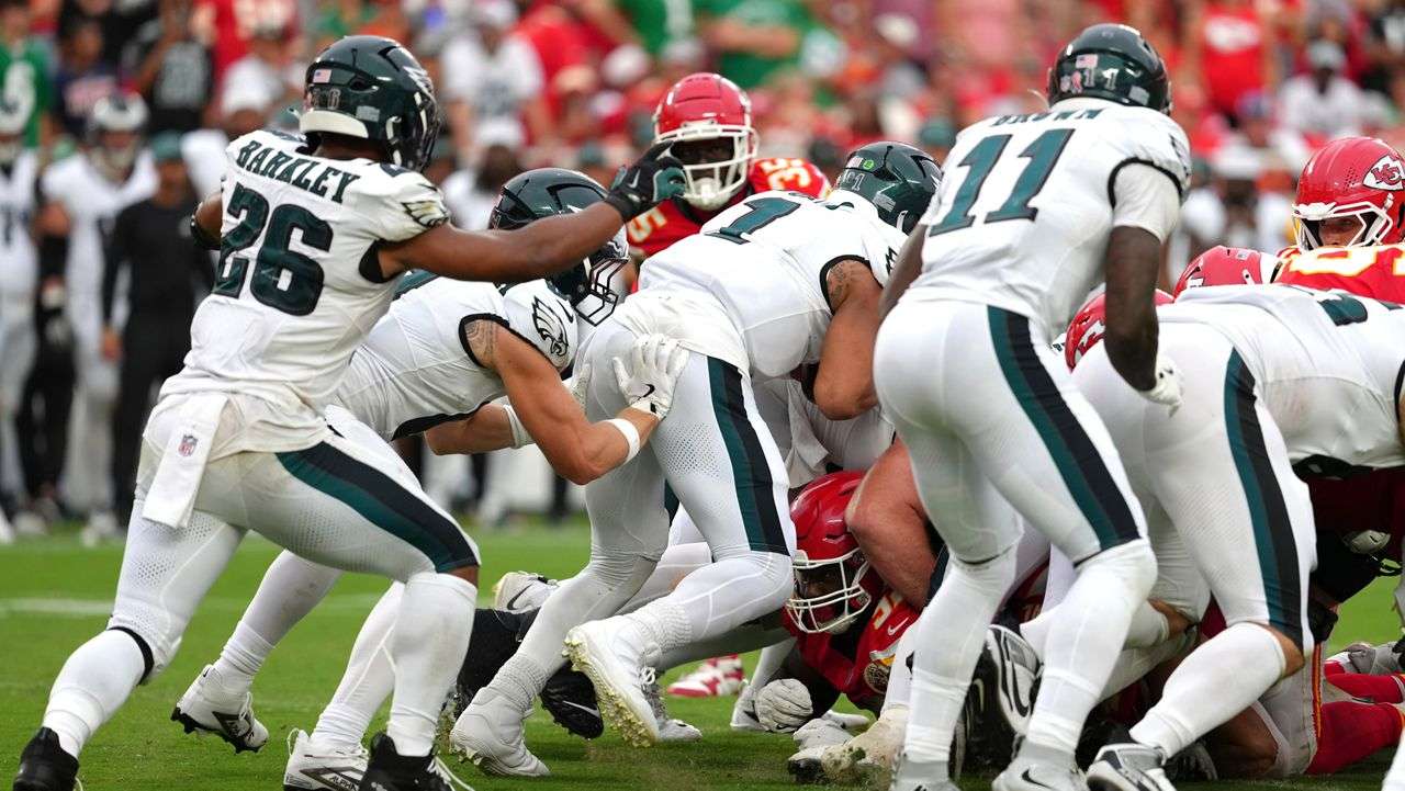 Philadelphia Eagles quarterback Jalen Hurts (1) gets a push from behind from Philadelphia Eagles tight end Grant Calcaterra (81) agains the Kansas City Chiefs in the second half during an NFL football game Sunday, Sept. 14, 2025, in Kansas City, Mo. (AP Photo/Ed Zurga)