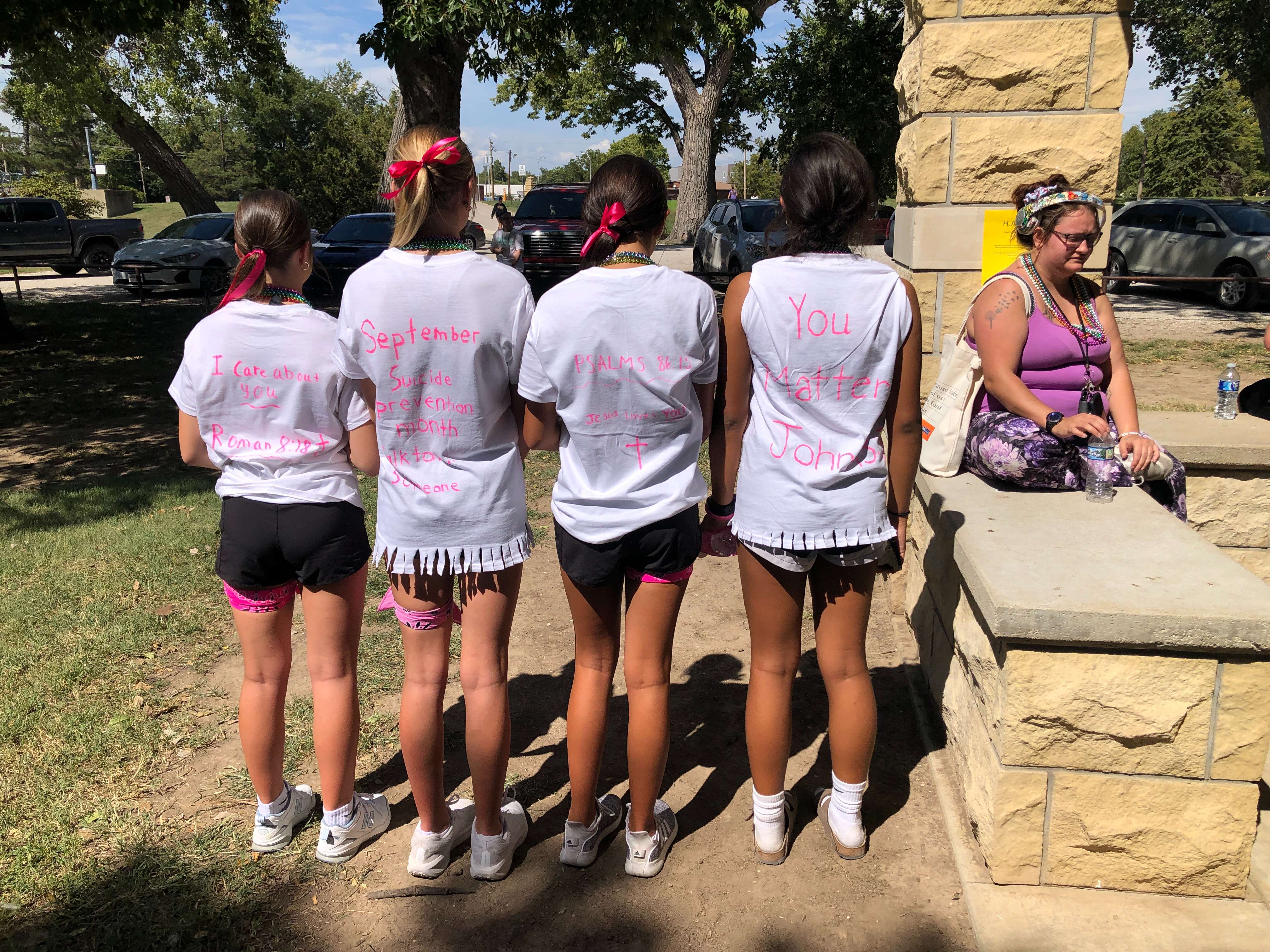 A group of middle school students who participated in the Out of Darkness Walk created their T-shirts with encouraging messages.&nbsp;Photo by Cristina Janney/Hays Post