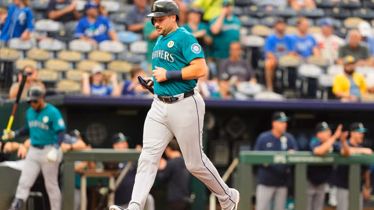 Seattle Mariners' Cal Raleigh runs home to score on a double by Julio Rodriguez during the first inning of a baseball game against the Kansas City Royals, Tuesday, Sept. 16, 2025, in Kansas City, Mo. (AP Photo/Charlie Riedel)