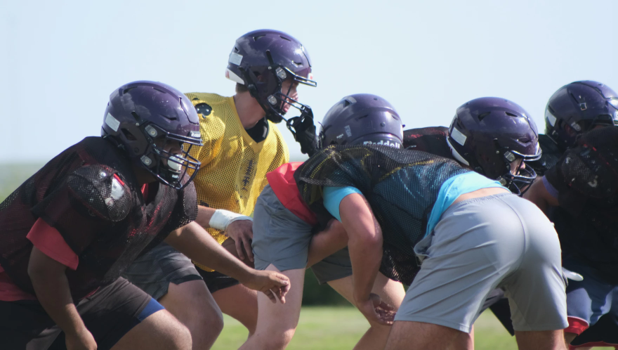 The Ingalls Bulldogs run through their walkthrough getting familiar with their plays. Kickoff for their team is right around the corner. Calen Moore / Kansas News Service