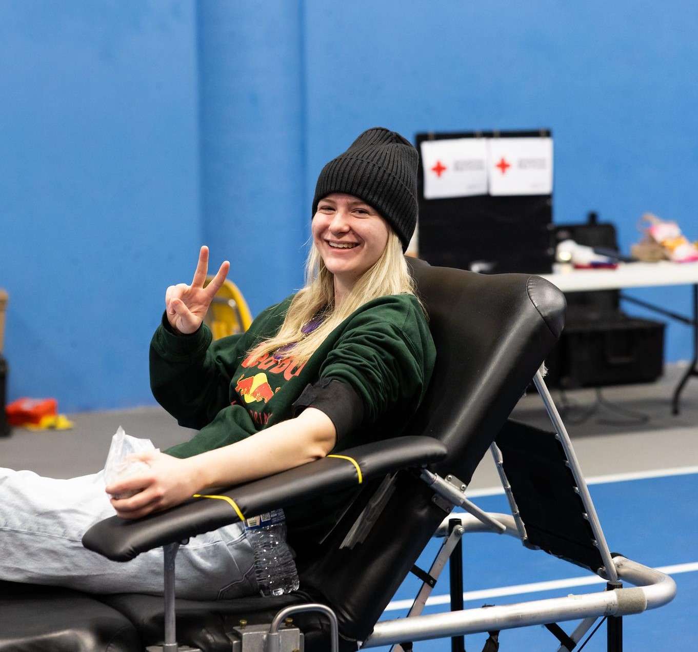 A blood donor pauses for a photo on the Barton campus at a previous blood drive.