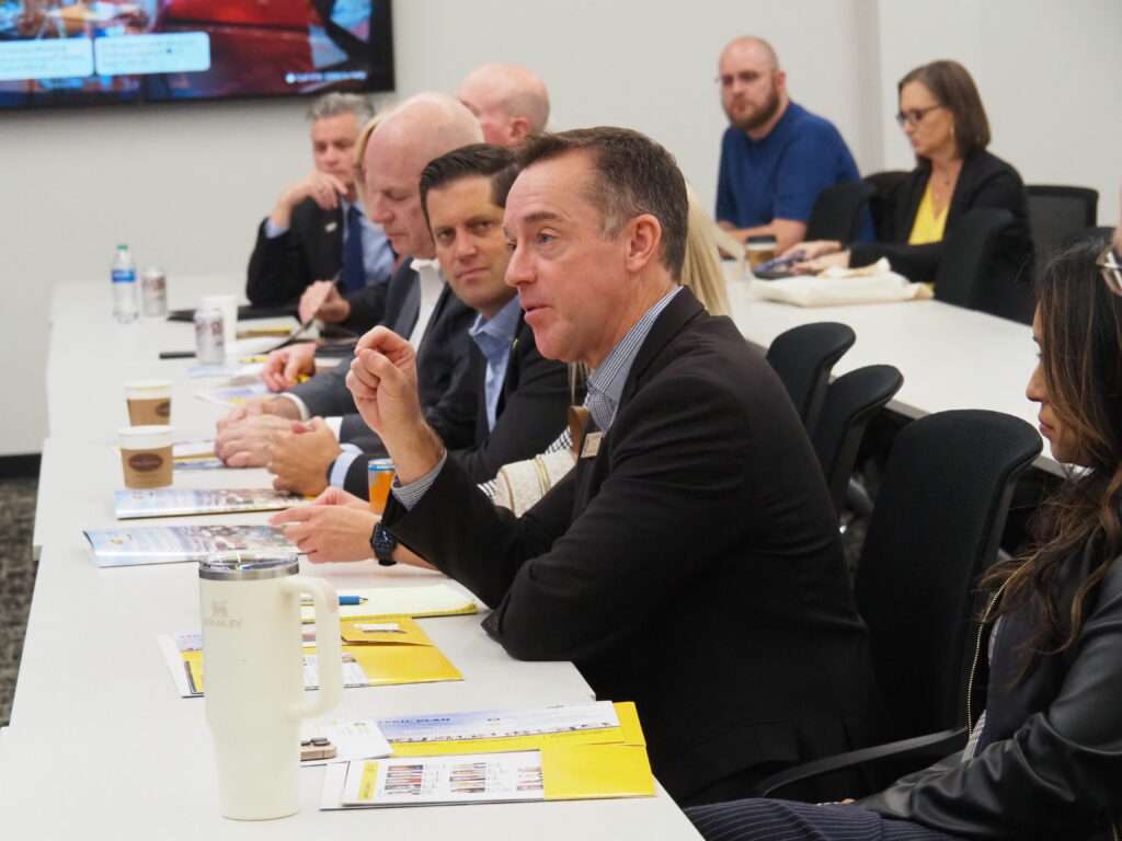 Blake Benson, chairman of the Kansas Board of Regents, says a modest $4.6 million cut in state aid to higher education may be palatable to the Kansas Legislature, which is likely to pursue greater budget austerity in the upcoming session. In this image, Benson tours the Wichita State University campus with other members of the Board of Regents in October 2024. (Tim Carpenter/Kansas Reflector)