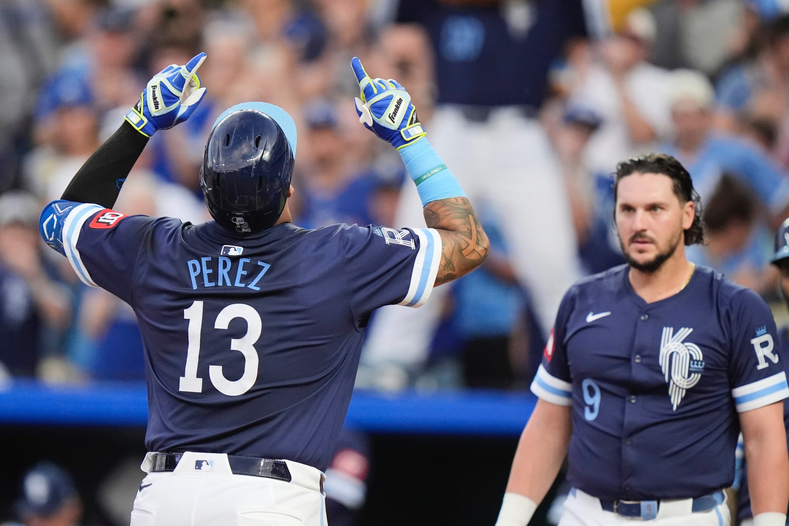 Kansas City Royals' Salvador Perez (13) celebrates as he crosses the plate after hitting a three-run home run during the first inning of a baseball game against the Toronto Blue Jays, Friday, Sept. 19, 2025, in Kansas City, Mo. (AP Photo/Charlie Riedel)