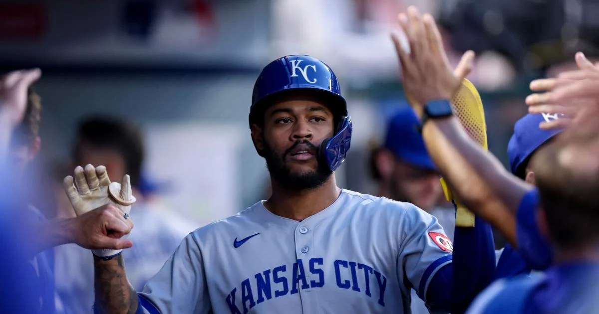 Kansas City Royals' Maikel Garcia (11) high fives teammates after scoring a run during the first inning of a baseball game against the Los Angeles Angels Tuesday, Sept. 23, 2025, in Anaheim, Calif. (AP Photo/Eric Thayer)