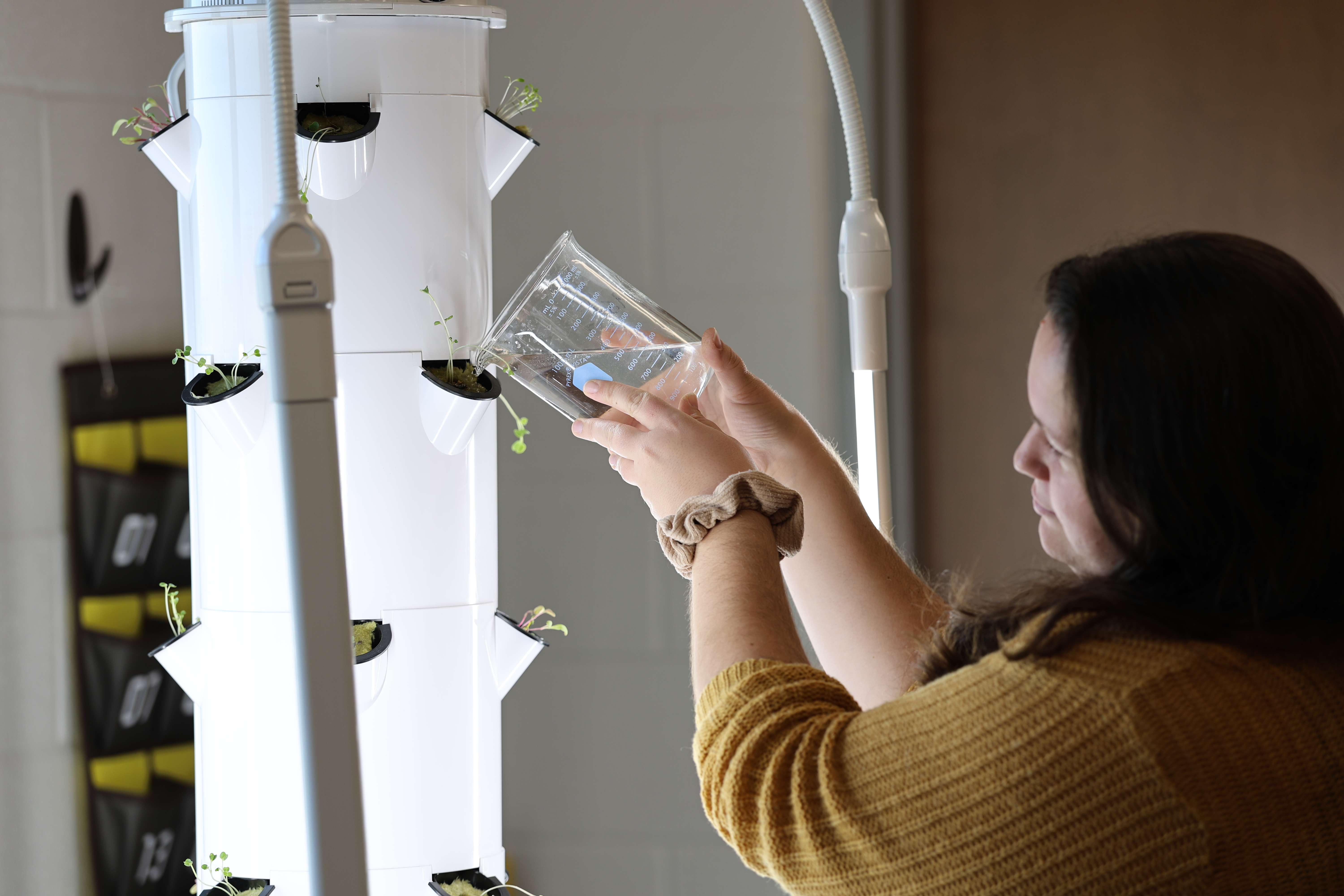 Pictured: Melissa Hoyle, JCHS Biology Teacher, waters plants with the Tower&nbsp;Garden&nbsp;System


