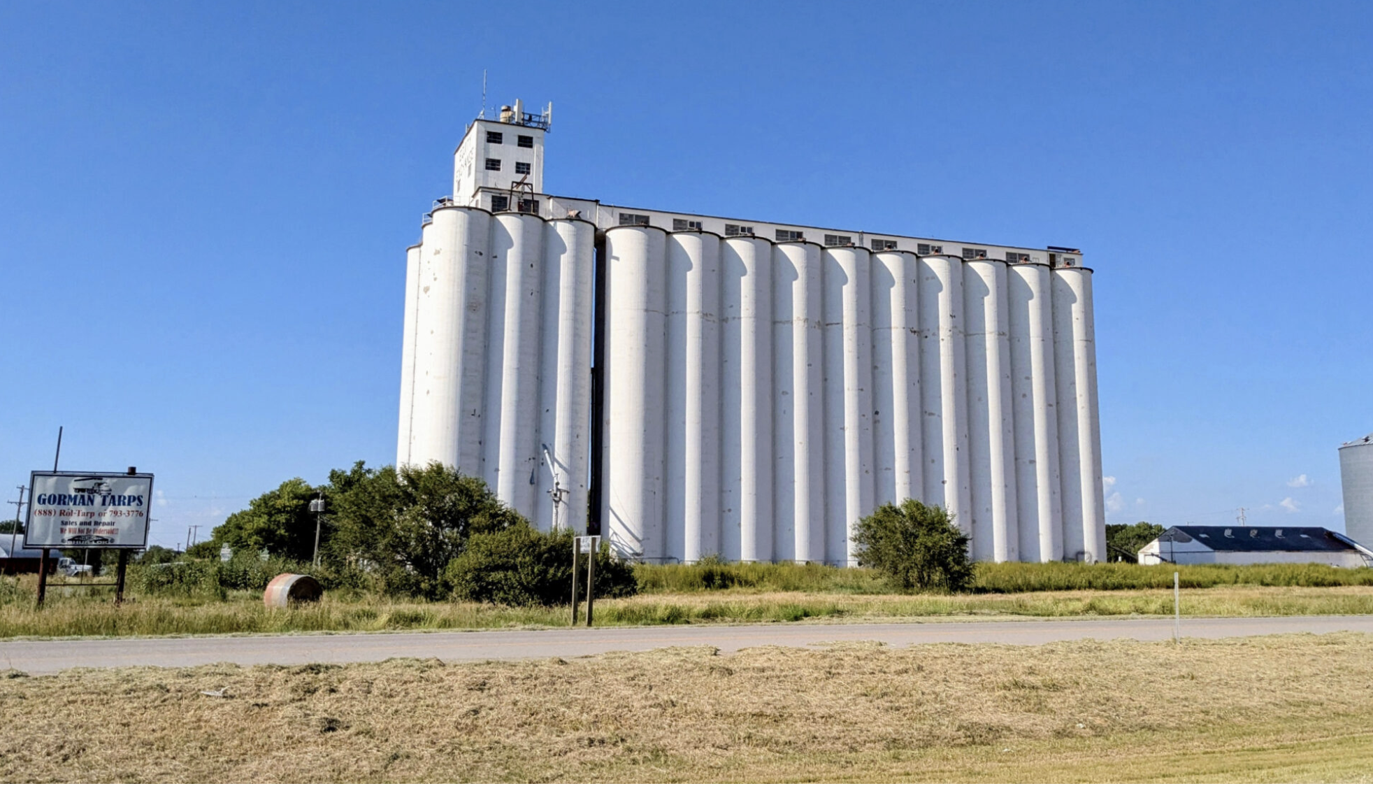  Kansas State University and Cowley County Community College will partner on an associate degree in milling science that could make use of grain stored in this Mullinville elevator on U.S. Highway 54. (Tim Carpenter/Kansas Reflector)