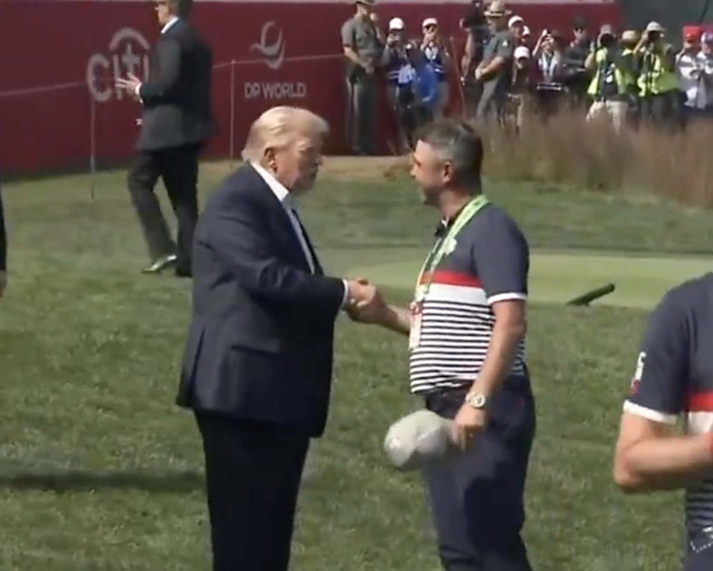 President Trump shakes hands with Former University of Kansas golfer Gary Woodland on the first tee Friday afternoon. Woodland is a vice captain on the 2025 Ryder Cup Team-image from CSPAN video