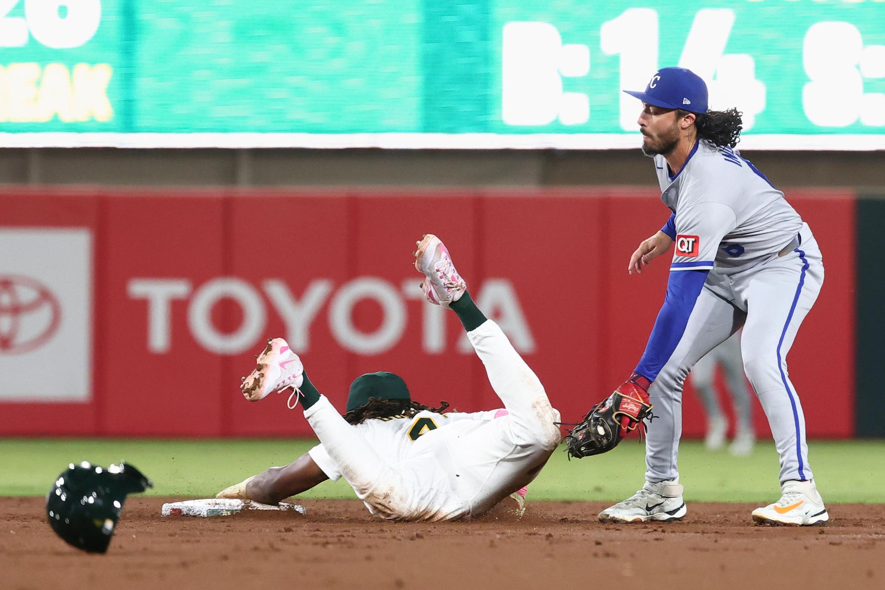 Kansas City Royals second baseman Jonathan India (6) attempts to tag out Athletics' Lawrence Butler as he steals second base during the second inning of a baseball game Friday, Sept. 26, 2025, in West Sacramento, Calif. (AP Photo/Sara Nevis)