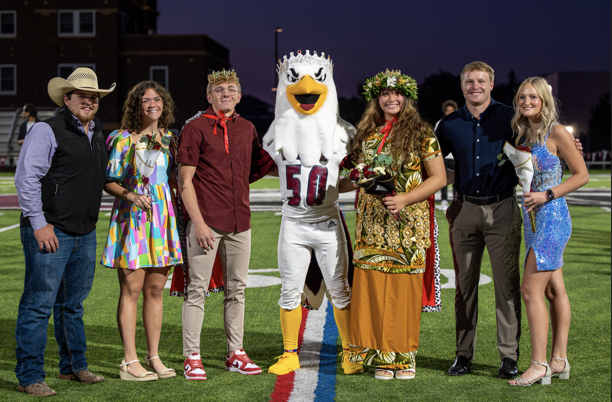 Chadron State College Homecoming royalty pose following coronation on Elliott Field Sept. 25, 2025. From left, Attendants Levi Van Beek of Crawford, Neb., Tianna Martin of Kearney, Neb., King Cort Rummel of Gurley, Neb., Elmo the Eagle mascot, Queen Natali Keni of Kahuku, Hawaii, attendants Liam Blaser of Duncan, Neb., and Kiauna Hergens of Parkston, S.D. (Photo by Tena L. Cook/Chadron State College)