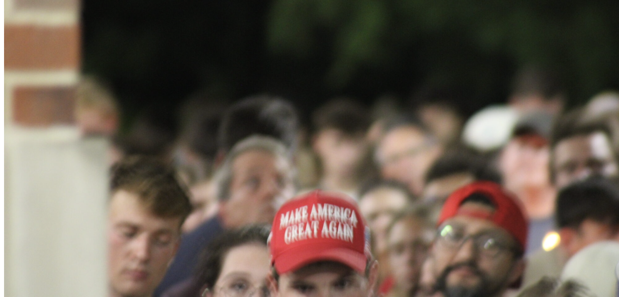 An attendee of a Charlie Kirk vigil at the University of Nebraska-Lincoln wearing a “Make America Great Again” hat on Sept 17. 2025. (Juan Salinas II/Nebraska Examiner)