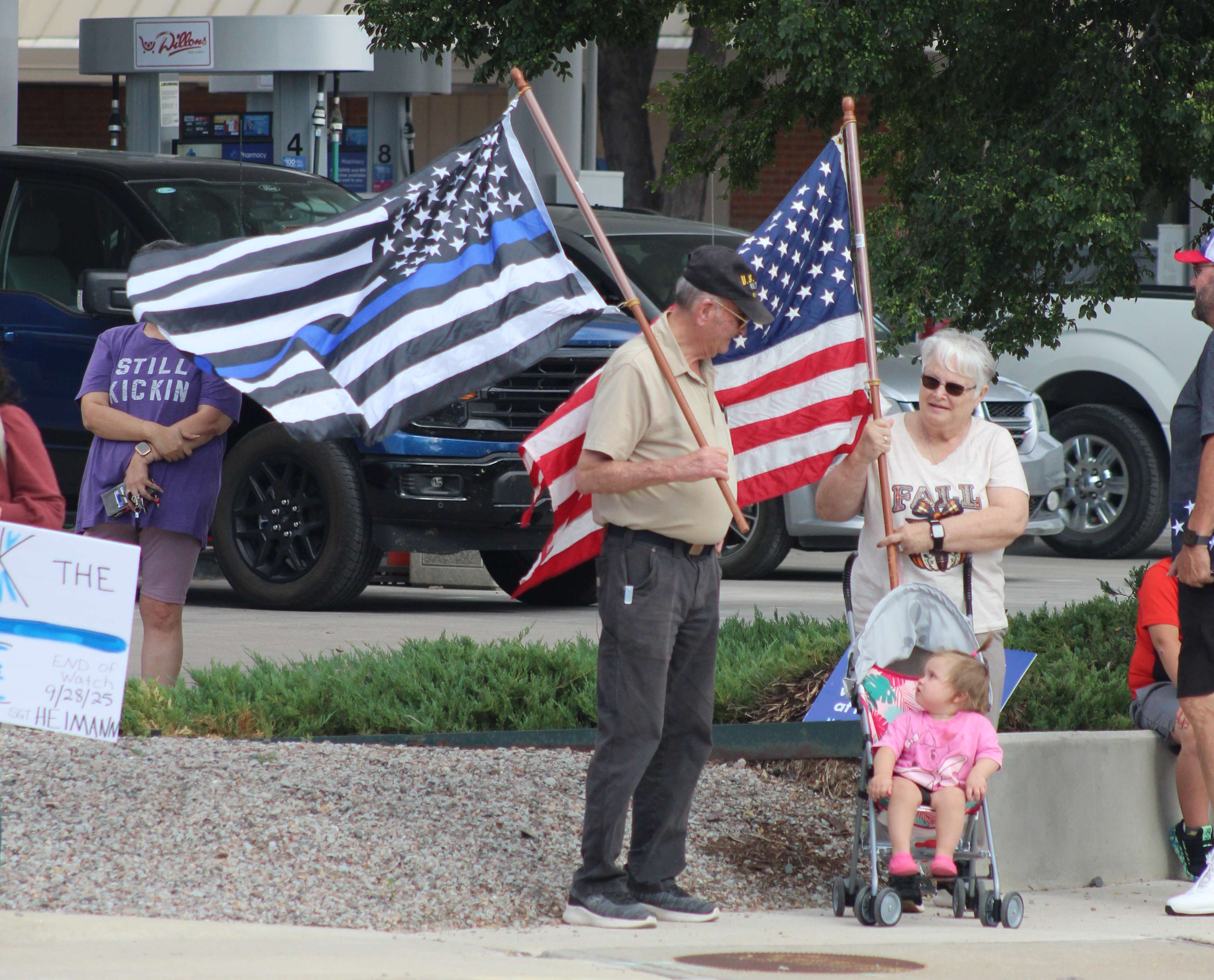 People carried flags to honor Hays Police Sgt. Scott Heimann on Tuesday as his escort entered Hays.&nbsp;Photo by Cristina Janney/Hays Post