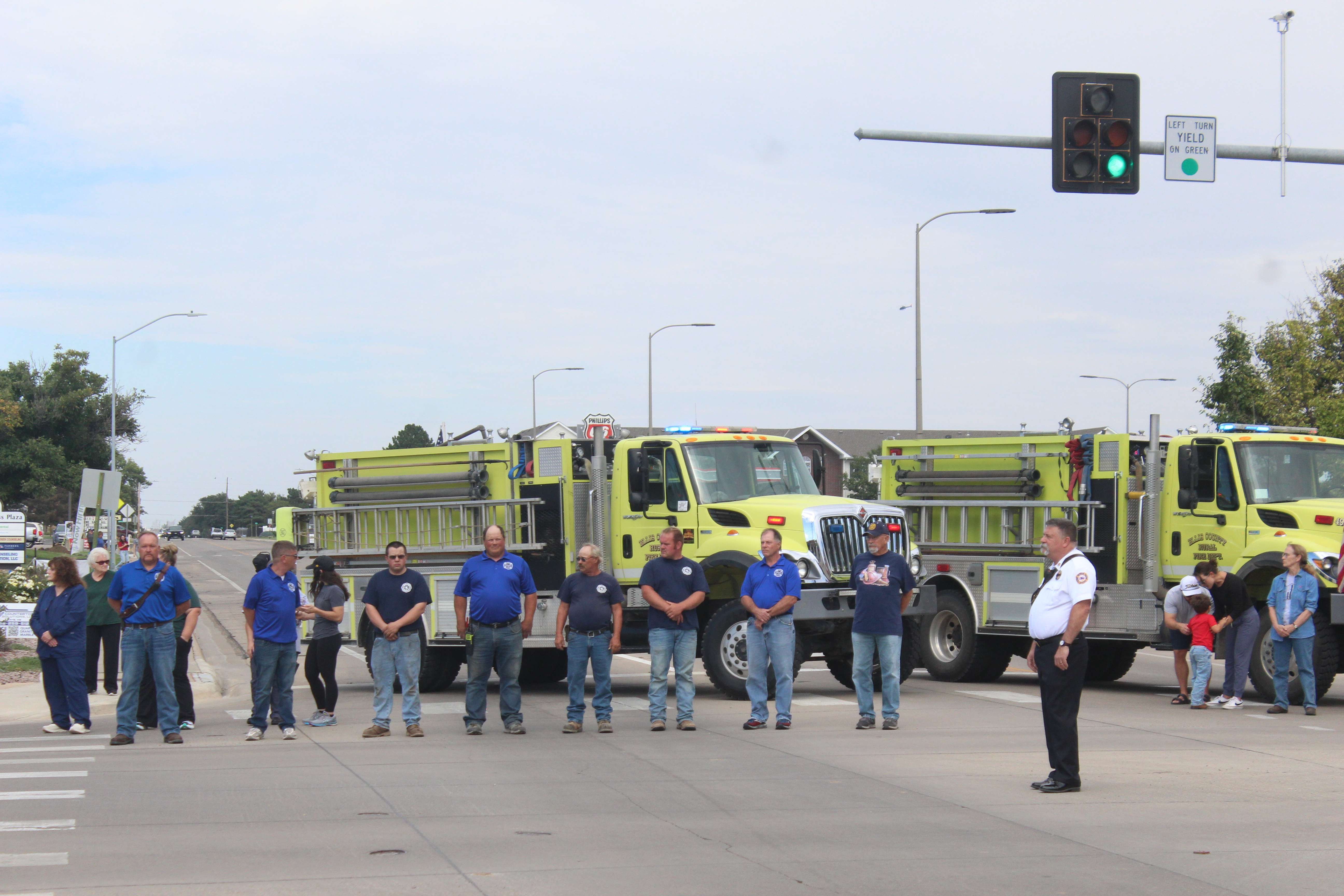 Members of the Ellis County Rural Fire wait for Sgt. Scott Heimann 'sescort on Tuesday. They were joined by hundreds of more people to honor the fallen Hays Police officer, who was killed in the line of duty on Sunday.&nbsp;Photo by Cristina Janney/Hays Post