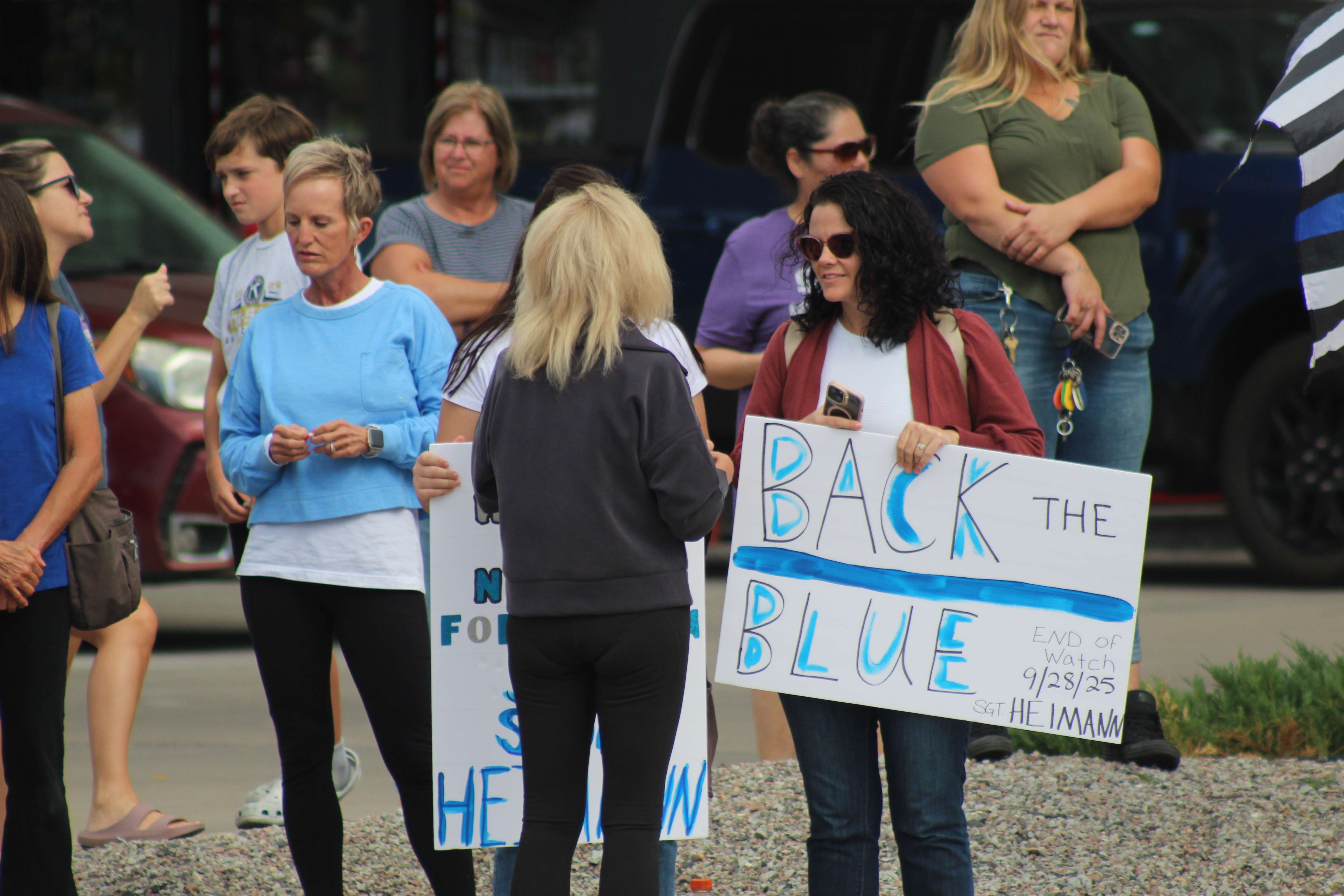 Supporters at the corner of 27th and Hall in Hays await the escort for Sgt. Scott Heimann, who was killed in the line of duty on Sunday. Photo by Cristina Janney/Hays Post