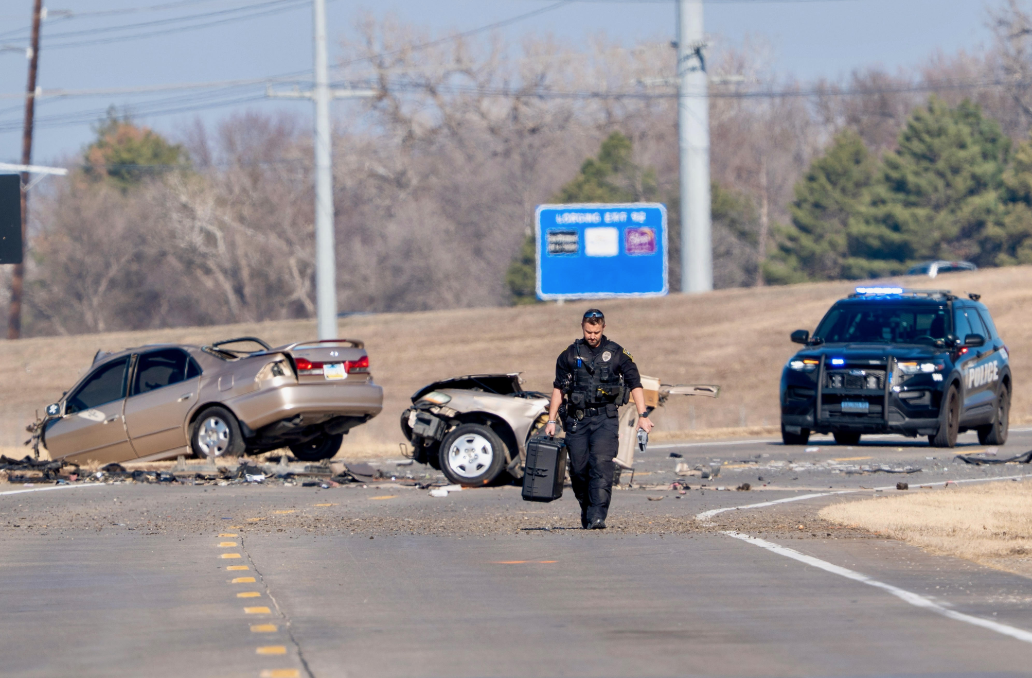 Salina Police officer on the scene of three-vehicle crash that occured along Centennial Road on Sunday, January 4. Photo by Tanner Colvin