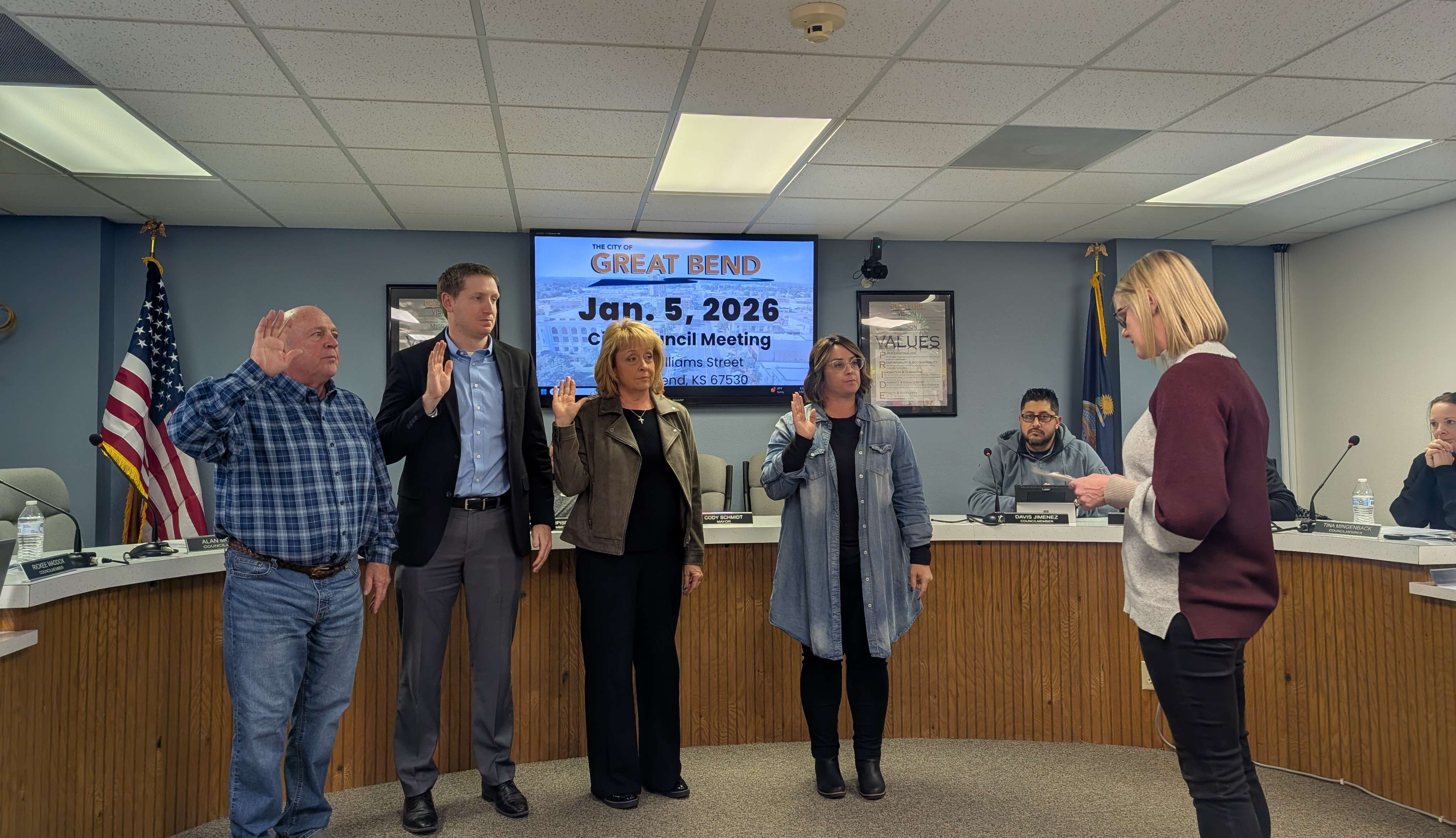 Great Bend City Clerk Shawna Schafer swears in new mayor Alan Moeder (left) and new council members Jay Luerman, Shelly Arnberger, and Shelly Peacock during Monday's meeting.