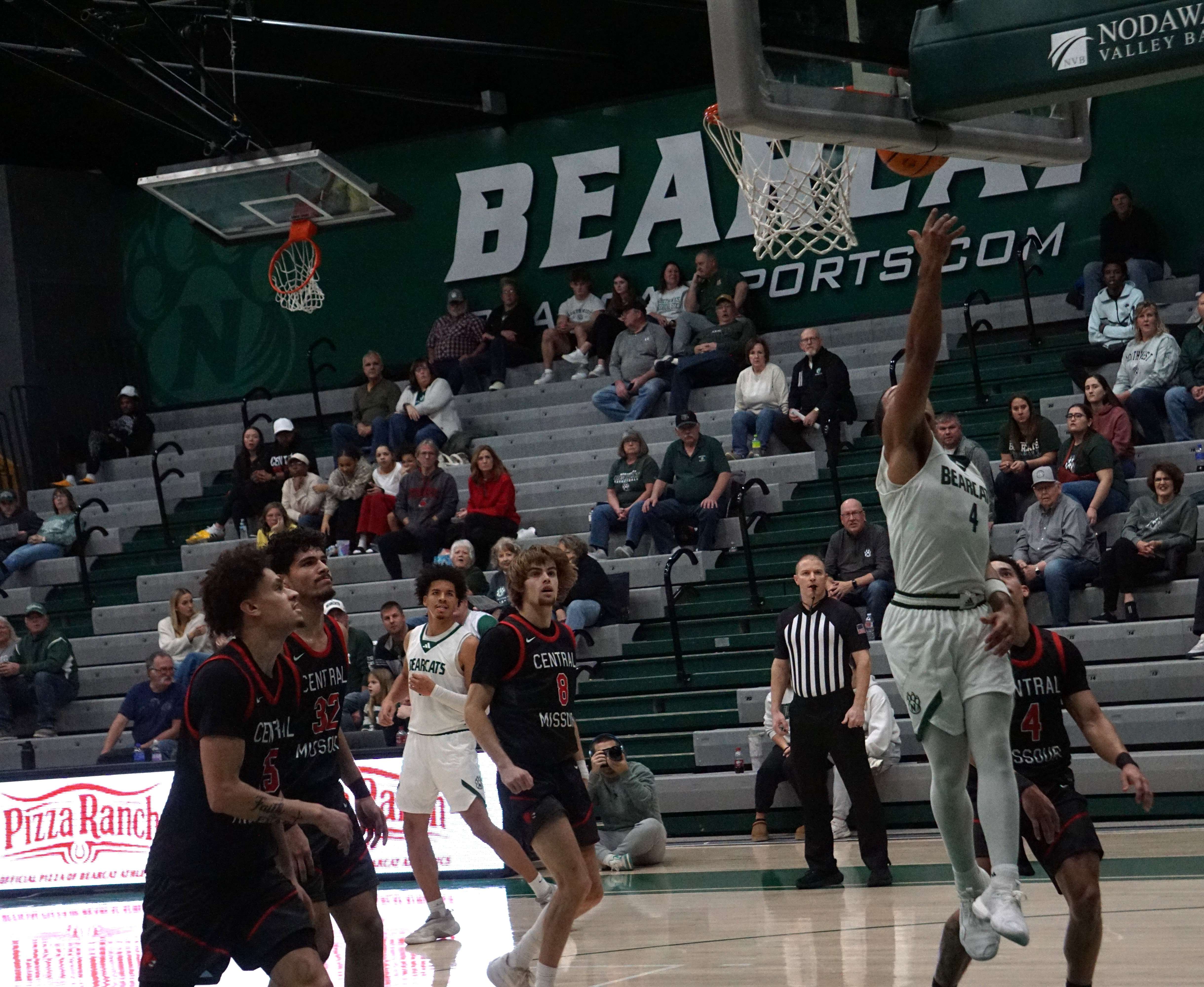 Northwest's Royce Williams (4) lays in a bucket for two of his team leading 18 points as the Bearcats narrowly fell to UCM 76-72/ Photo by Matt Pike
