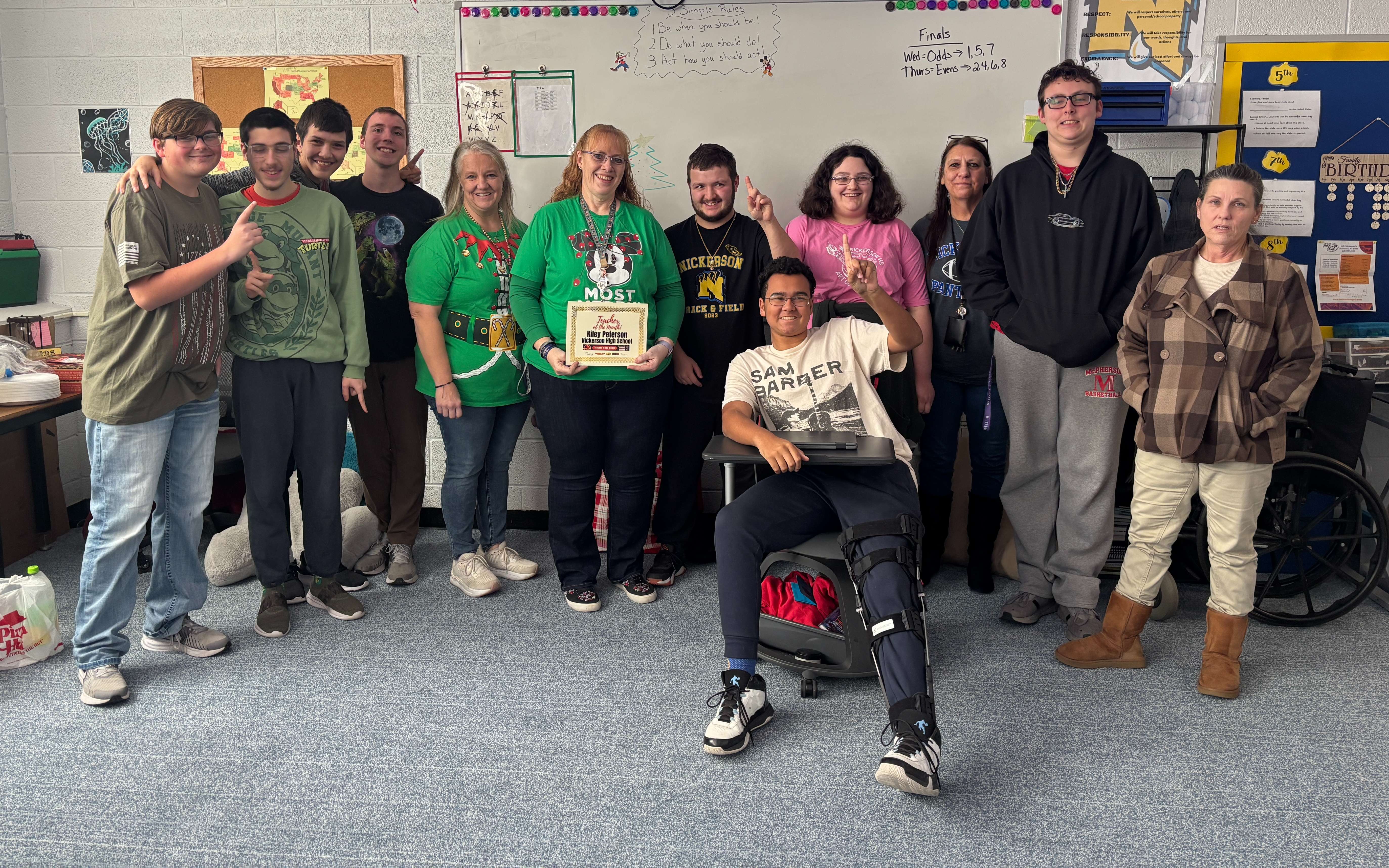 Kily Peterson, center, poses with the Teacher of the Month award alongside students from her Adaptive Special Education class after being named December’s Teacher of the Month at Nickerson High School. The award is sponsored by Allen Samuels Chrysler Dodge Jeep Ram.