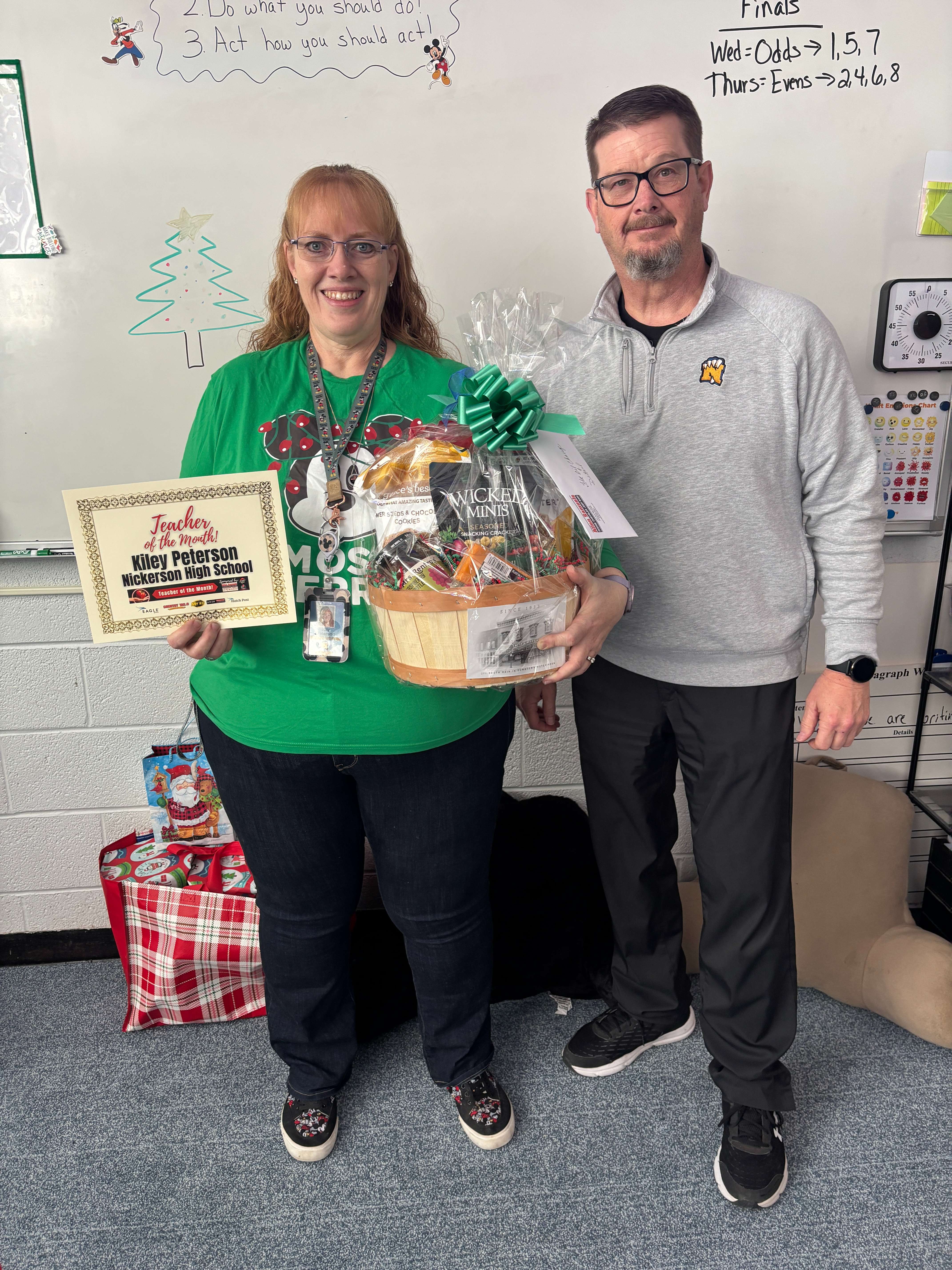 Kily Peterson, left, poses with the Teacher of the Month award alongside Nickerson High School Principal Rick Blosser, after being named December’s Teacher of the Month at Nickerson High School. The award is sponsored by Allen Samuels Chrysler Dodge Jeep Ram.