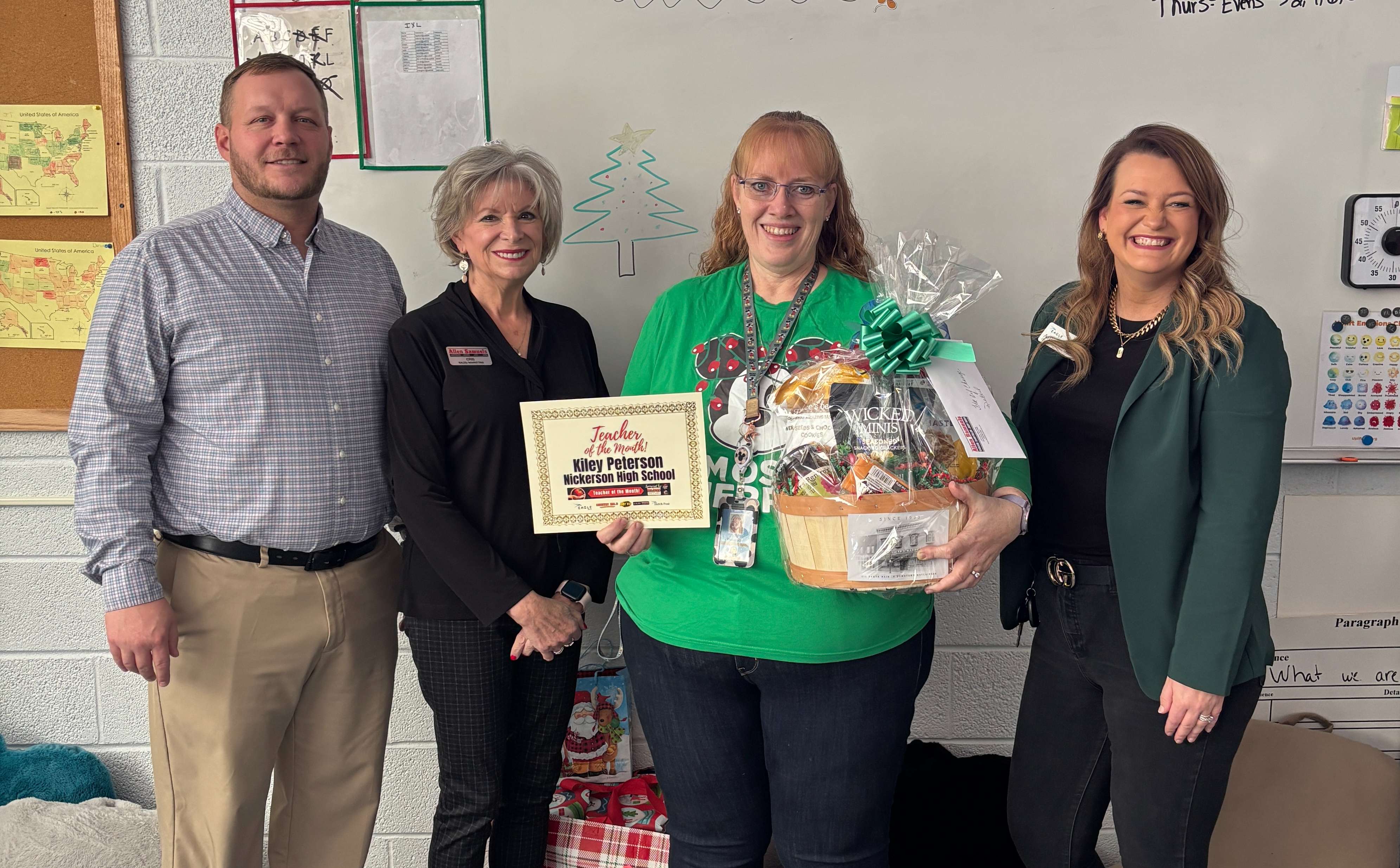 From left, Tyler Ritter of Allen Samuels Chrysler Dodge Jeep Ram, Cris Schul of Allen Samuels Chrysler Dodge Jeep Ram, Kily Peterson, and Ashley Weve of Eagle Media pose during a presentation recognizing Peterson as December’s Teacher of the Month at Nickerson High School. The award is sponsored by Allen Samuels Chrysler Dodge Jeep Ram.