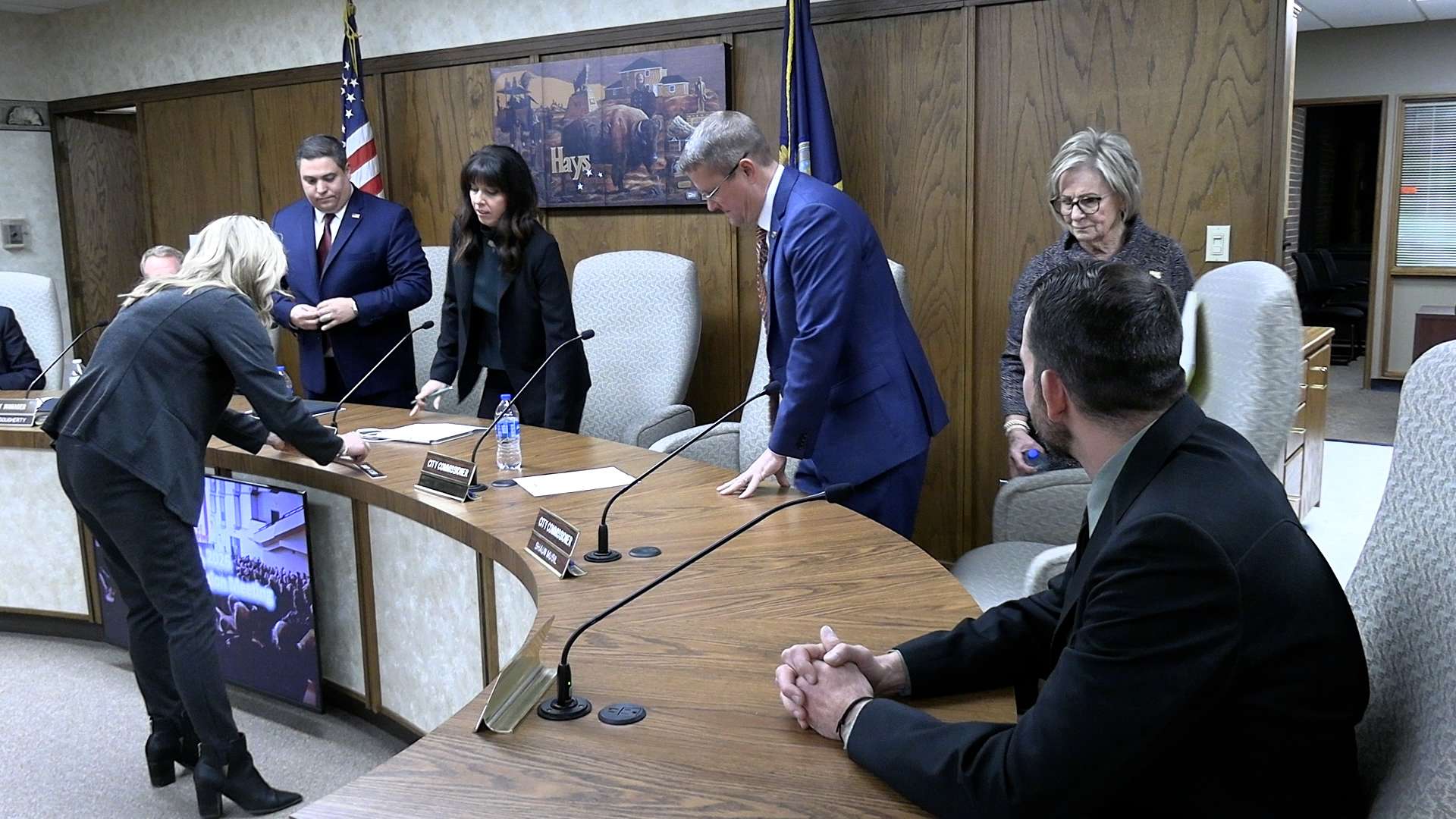 Andrea Winholz, executive assistant, rearranges name plates after the Hays City Commission governing body was reorganized on Jan. 8. Pictured are Mason Ruder, mayor, Alaina Cunningham, vice-mayor, Shaun Musil, Sandy Jacobs and David Vilaysing. Photo by Becky Kiser/Hays Post