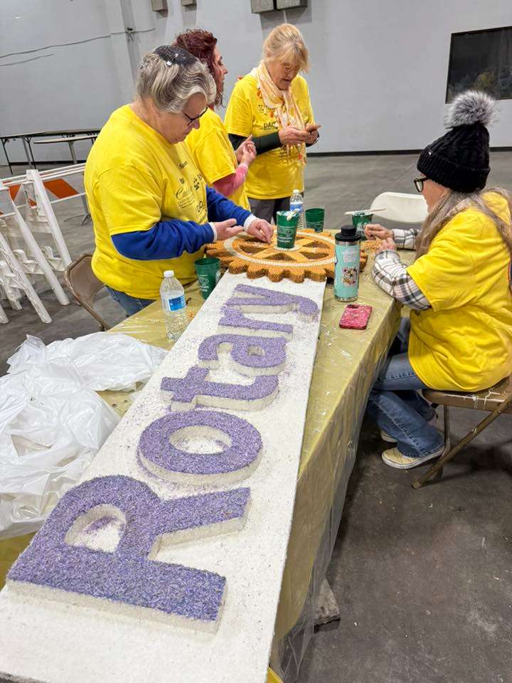 Volunteers placing beans on a Rotary logo for placement on a Tournament of Roses Parade float. (Photo courtesy Shirley Nisly)