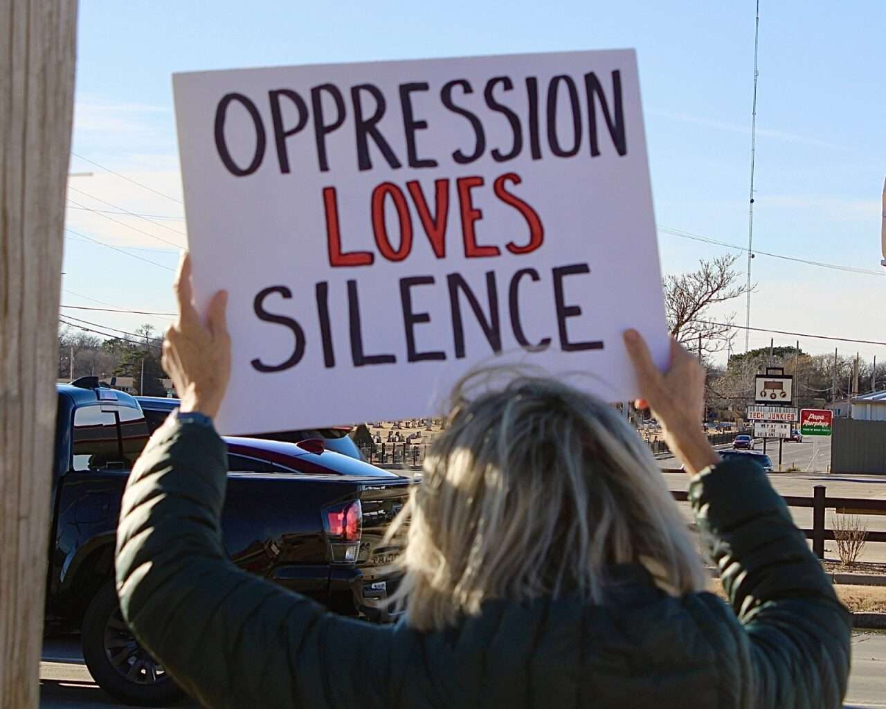 A protestor with a sign during Sunday's demonstration in Hays. Photo by Tony Guerrero/Hays Post