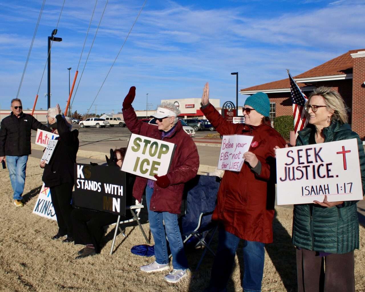 Protesters with signs on Sunday on the corner of 27th and Vine streets in Hays. Photo by Tony Guerrero/Hays Post