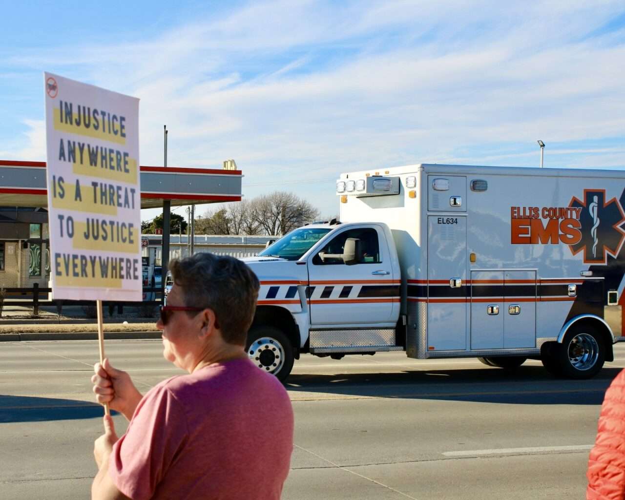 A protestor with a sign during Sunday's demonstration in Hays. Photo by Tony Guerrero/Hays Post