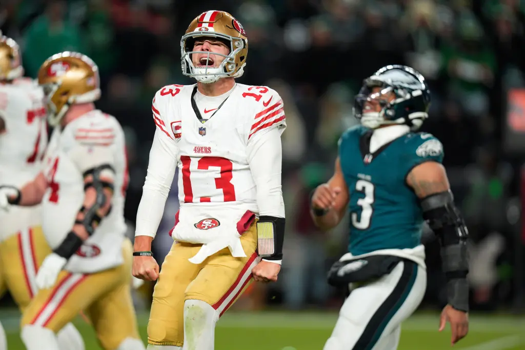 San Francisco 49ers quarterback Brock Purdy (13) reacts to a touchdown pass to 49ers running back Christian McCaffrey during the second half of an NFL wild-card playoff football game against the Philadelphia Eagles on Sunday, Jan. 11, 2026, in Philadelphia. (AP Photo/Chris Szagola)