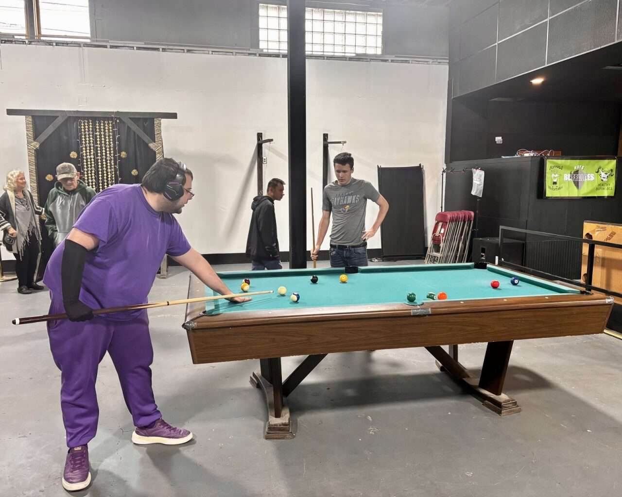Hays Buffaloes playing a game of pool at their new activity center in Hays. Photo by Tony Guerrero/Hays Post