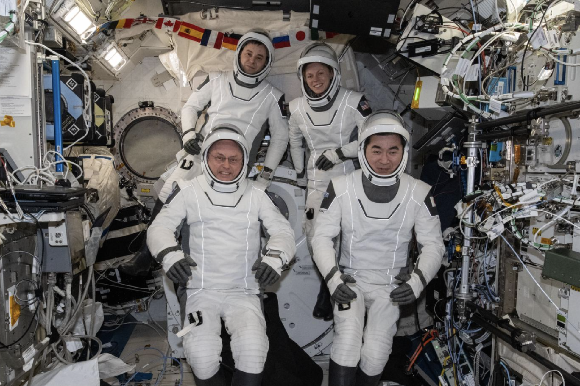 This photo provided by NASA shows clockwise from bottom left are, NASA astronaut Mike Fincke, Roscosmos cosmonaut Oleg Platonov, NASA astronaut Zena Cardman, and JAXA (Japan Aerospace Exploration Agency) astronaut Kimiya Yui gathering for a crew portrait wearing their Dragon pressure suits during a suit verification check inside the International Space Station’s Kibo laboratory module, Wednesday, Jan. 14, 2026.