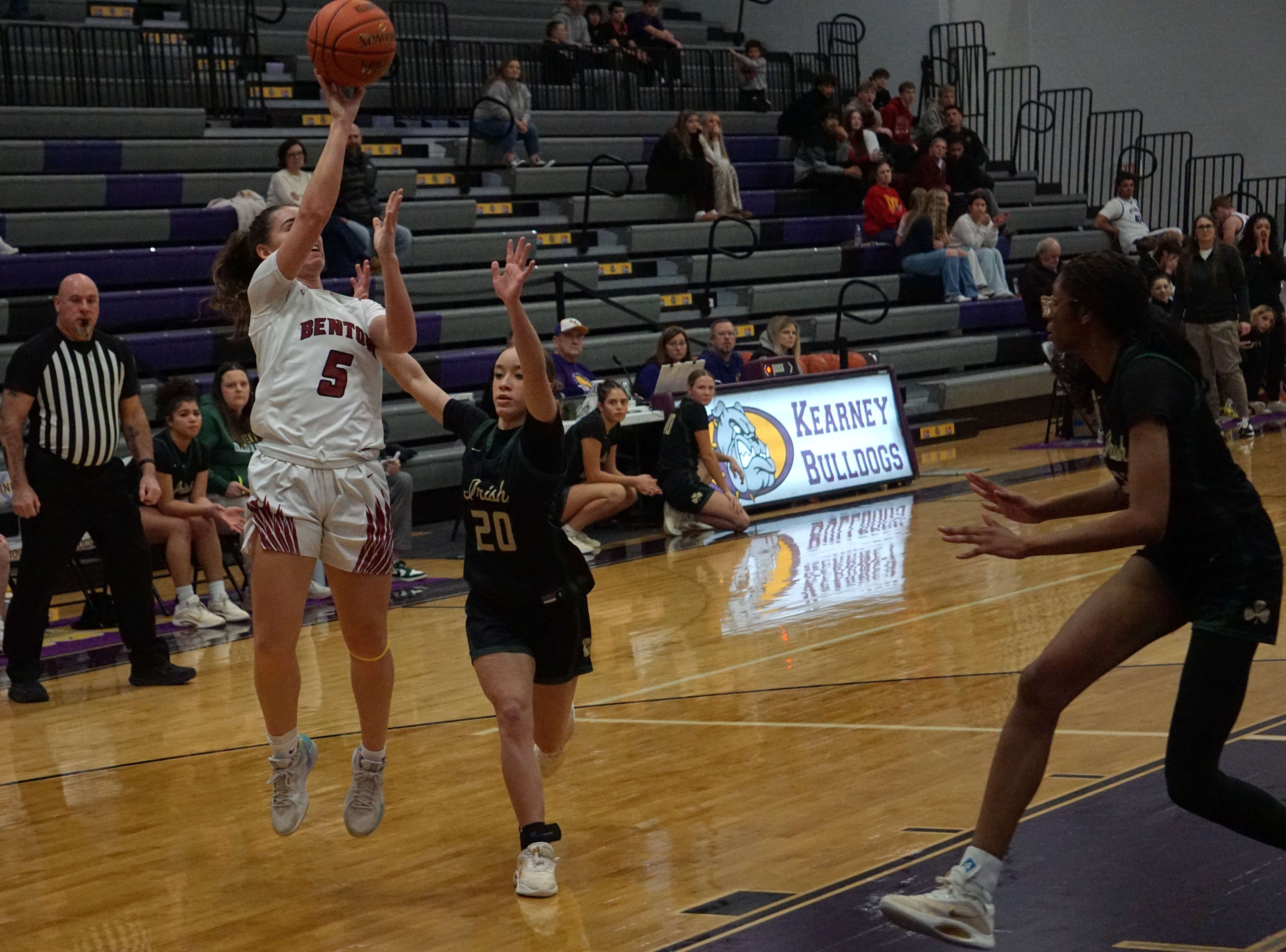 Eliana Arambula (5) goes for a layup against Nenah Ross (20) as Laniya Carriger (23) guards the paint/ Photo by Matt Pike