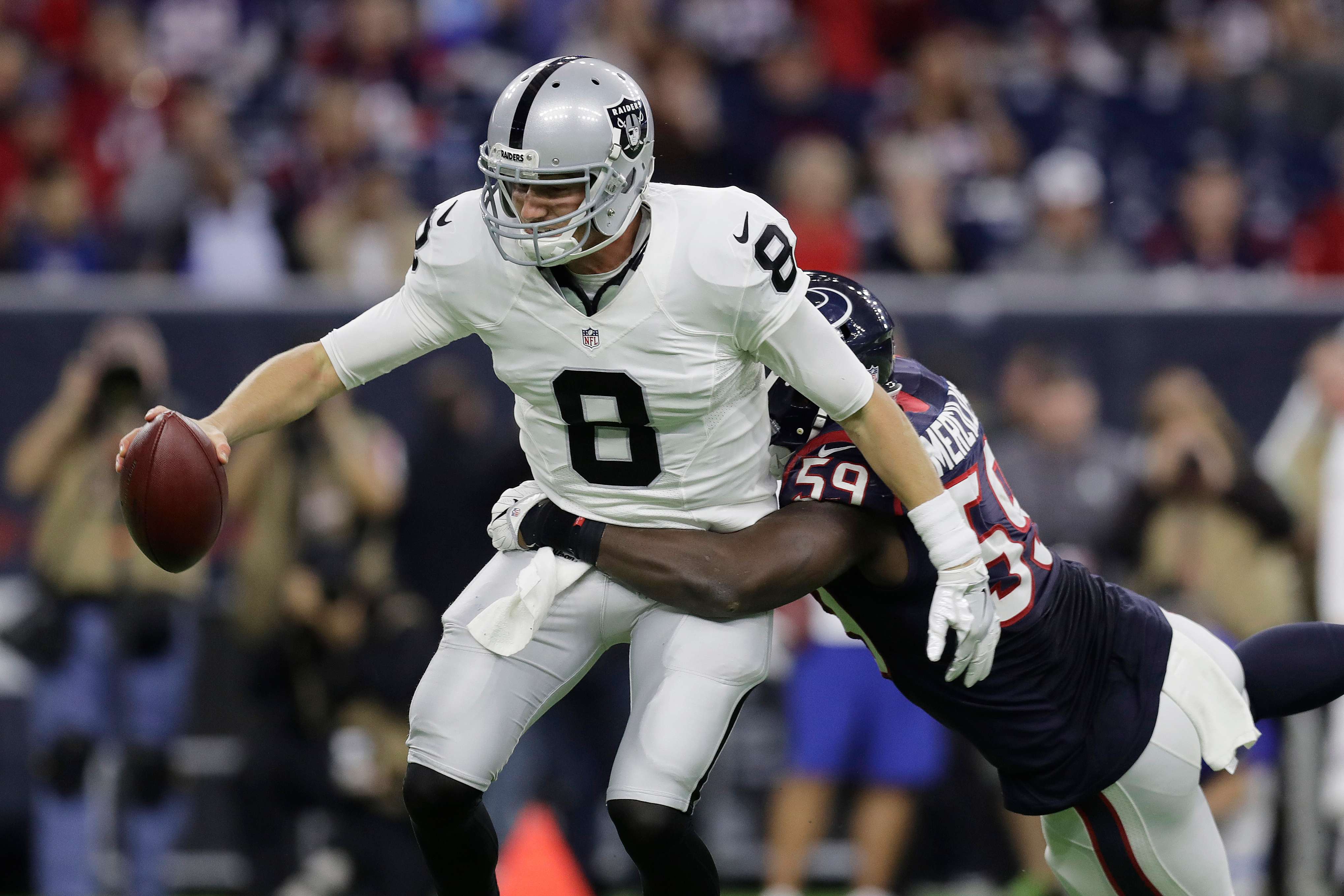 FILE - Oakland Raiders quarterback Connor Cook (8) is sacked by Houston Texans outside linebacker Whitney Mercilus (59) during the second half of an AFC Wild Card NFL football game Jan. 7, 2017, in Houston. (AP Photo/Eric Gay, File)