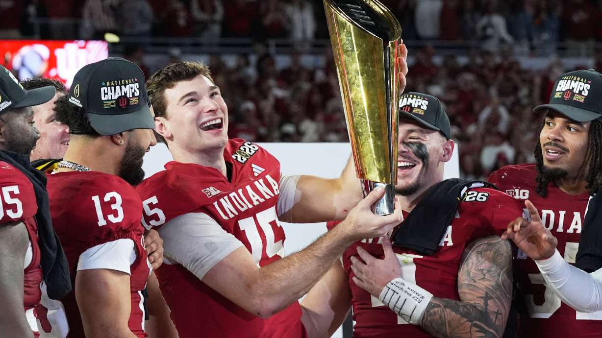 Indiana quarterback Fernando Mendoza holds the trophy after their win against Miami in the College Football Playoff national championship game, Monday, Jan. 19, 2026, in Miami Gardens, Fla. (AP Photo/Marta Lavandier)