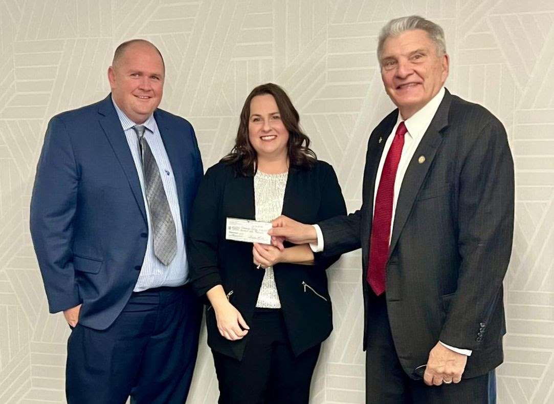 WNCC President Greg Dart and Board Chair John Stinner (right) accept a check for $15,000 from NPPD Account Manager Jennifer Branson. The funds were raised from the 34th annual Wells Fargo Nebraska Open in the fall.