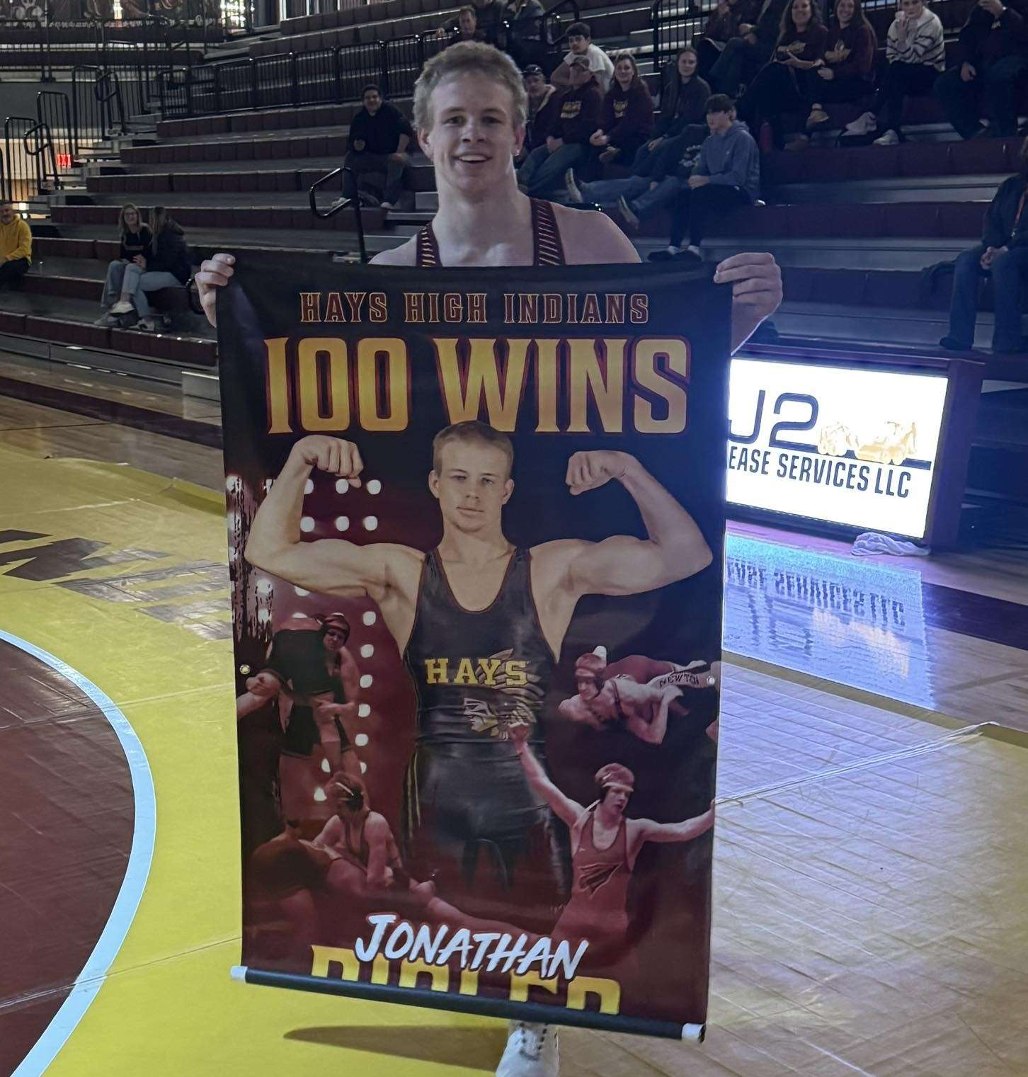 Hays High's Johnny Rigler celebrates his 100th career wrestling win following a dual against Great Bend on Tuesday, January 20, 2026 in Hays, Kan. (Courtesy photo)