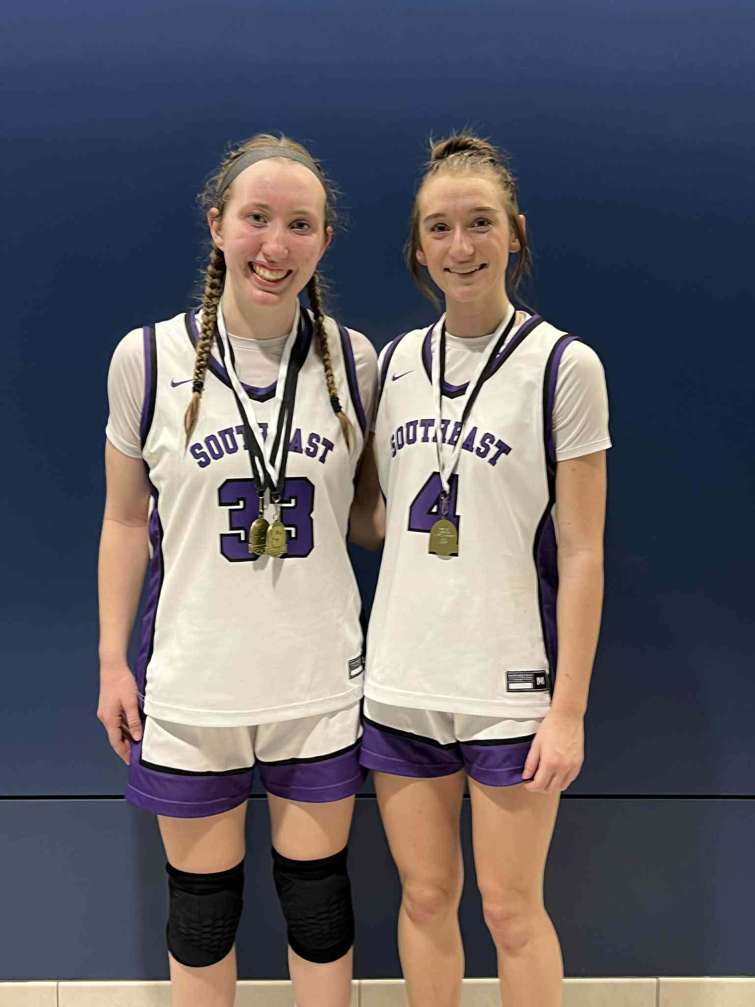 Aba Pearson (33) and Kyiah Samuelson (4) wearing their all-tournament medals.