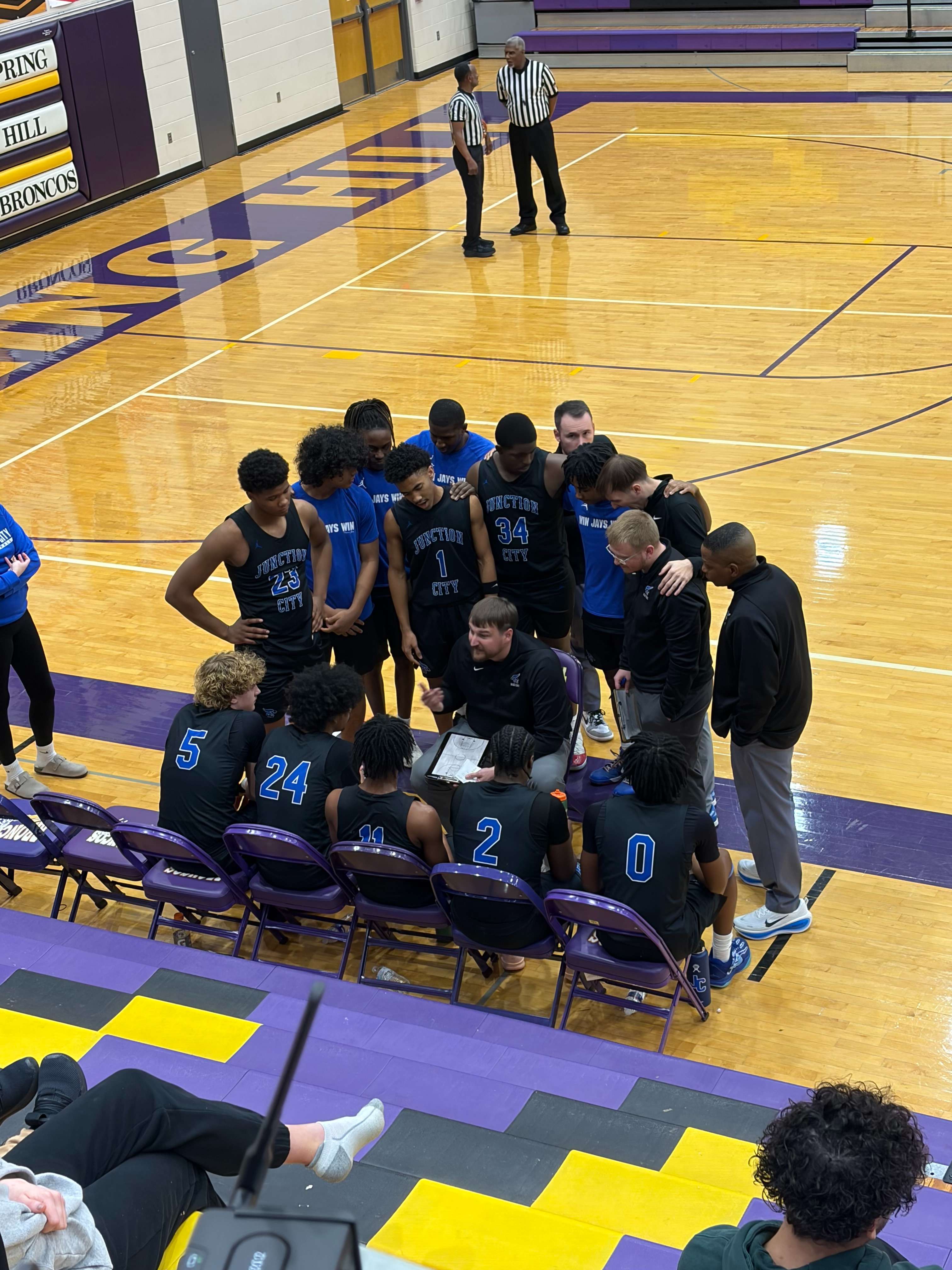 Junction City Boys basketball coach Easton Burgardt draws up a play in the Championship game at the Spring Hill Invitational Tournament.
