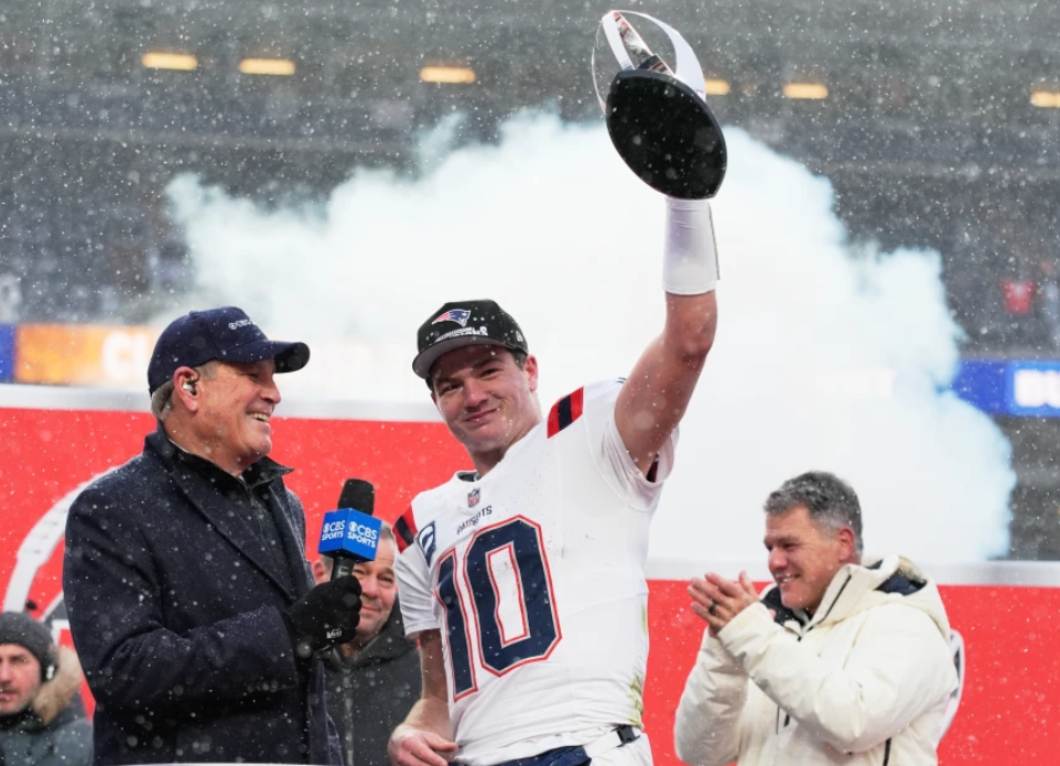 New England Patriots quarterback Drake Maye celebrates with the trophy after the AFC Championship NFL football game between the Denver Broncos and the New England Patriots, Sunday, Jan. 25, 2026, in Denver. (AP Photo/John Locher)