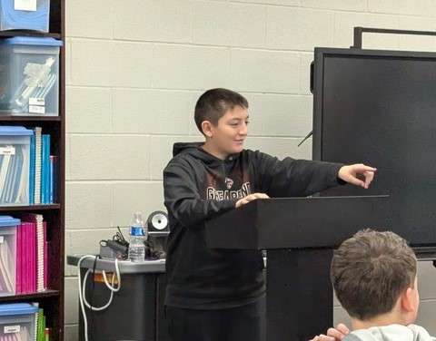 Wyatt Holguin presents his commitment letter to All Stars graduates at Lincoln Elementary.