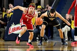 Nebraska guard Sam Hoiberg (1) steals the ball from Michigan center Aday Mara (15) in the first half of an NCAA college basketball game in Ann Arbor, Mich., Tuesday, Jan. 27, 2026. (AP Photo/Lon Horwedel)