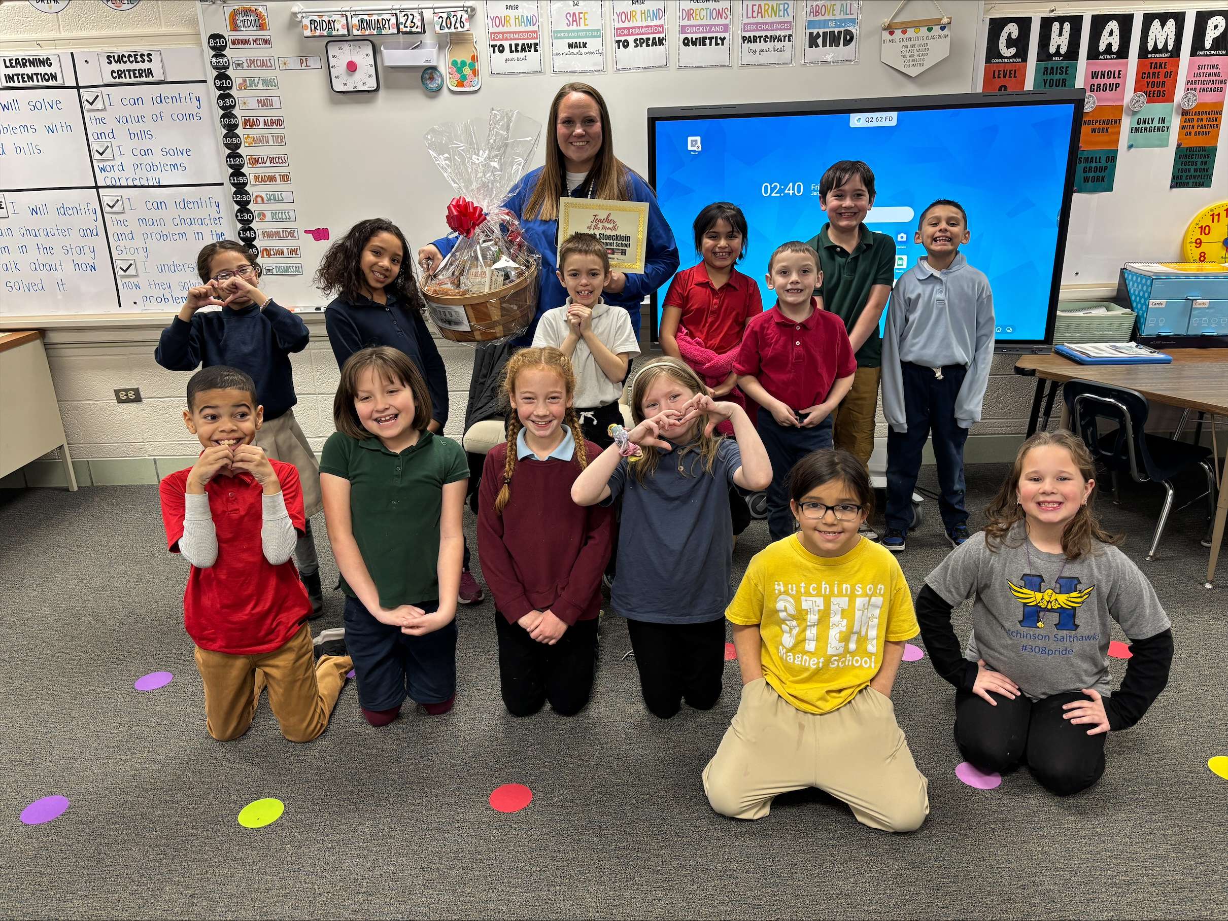 Allen STEM Magnet School second-grade teacher Hannah Stoecklein, the January Teacher of the Month presented by Allen Samuels Chrysler Dodge Jeep Ram, is pictured with her class after receiving the award. (Hutch Post photo)