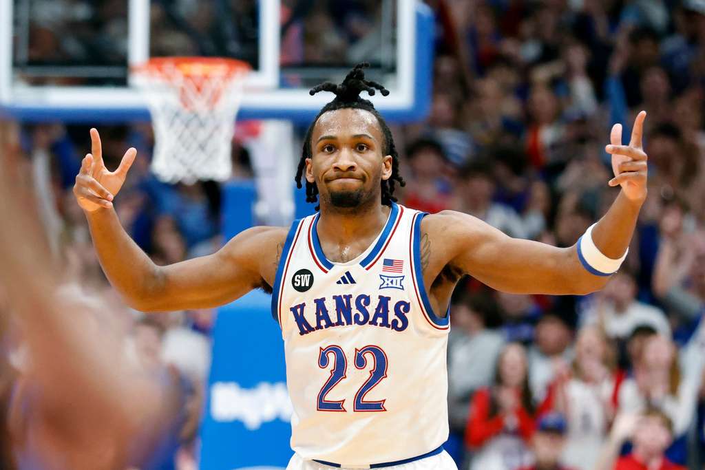 Kansas guard Darryn Peterson (22) reacts after scoring a three-point basket during the first half of an NCAA college basketball game against BYU, Saturday, Jan. 31, 2026, in Lawrence, Kan. (AP Photo/Colin E. Braley)