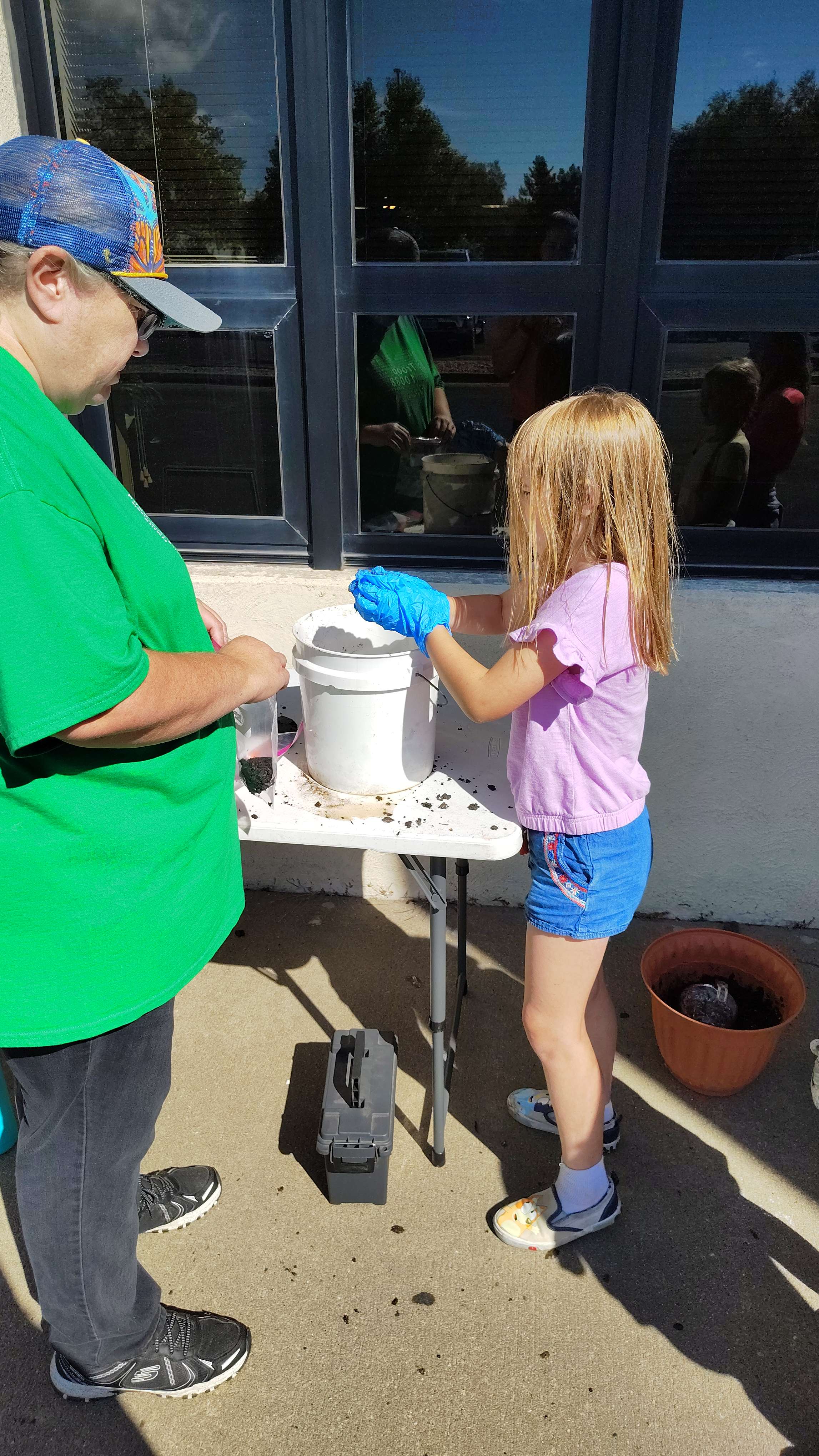 A Girl Scout makes a seed ball that contains wildflower and milkweed seeds to plant at home during Magical Monarchs Saturday at the Sternberg Museum. Milkweed is the only plant that monarch butterfly caterpillars will eat. Courtesy photo