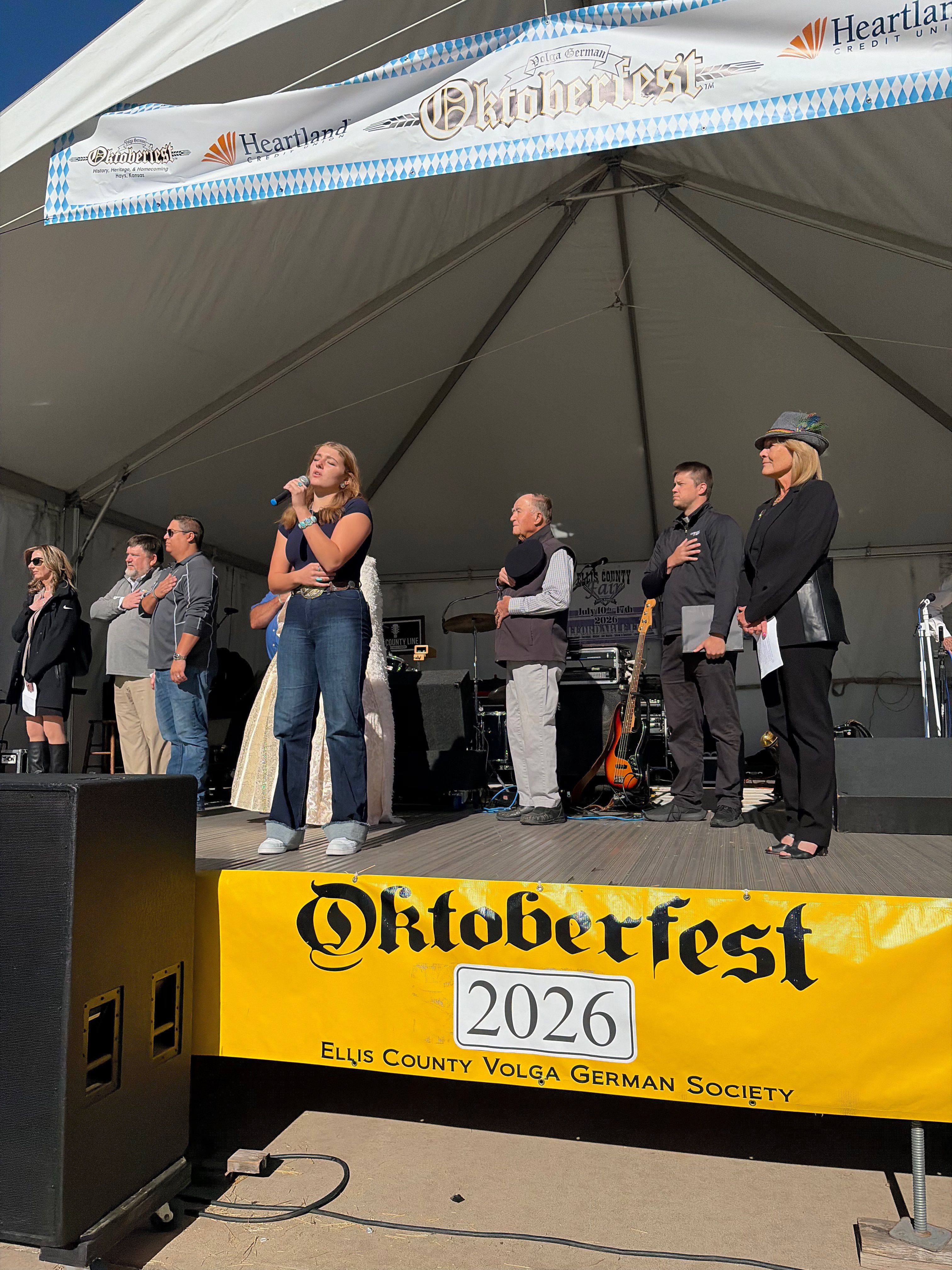 Gracie Herl singing the national anthem at Oktoberfest Hays 2026. Photo by Alin Hett/Hays Post.&nbsp;