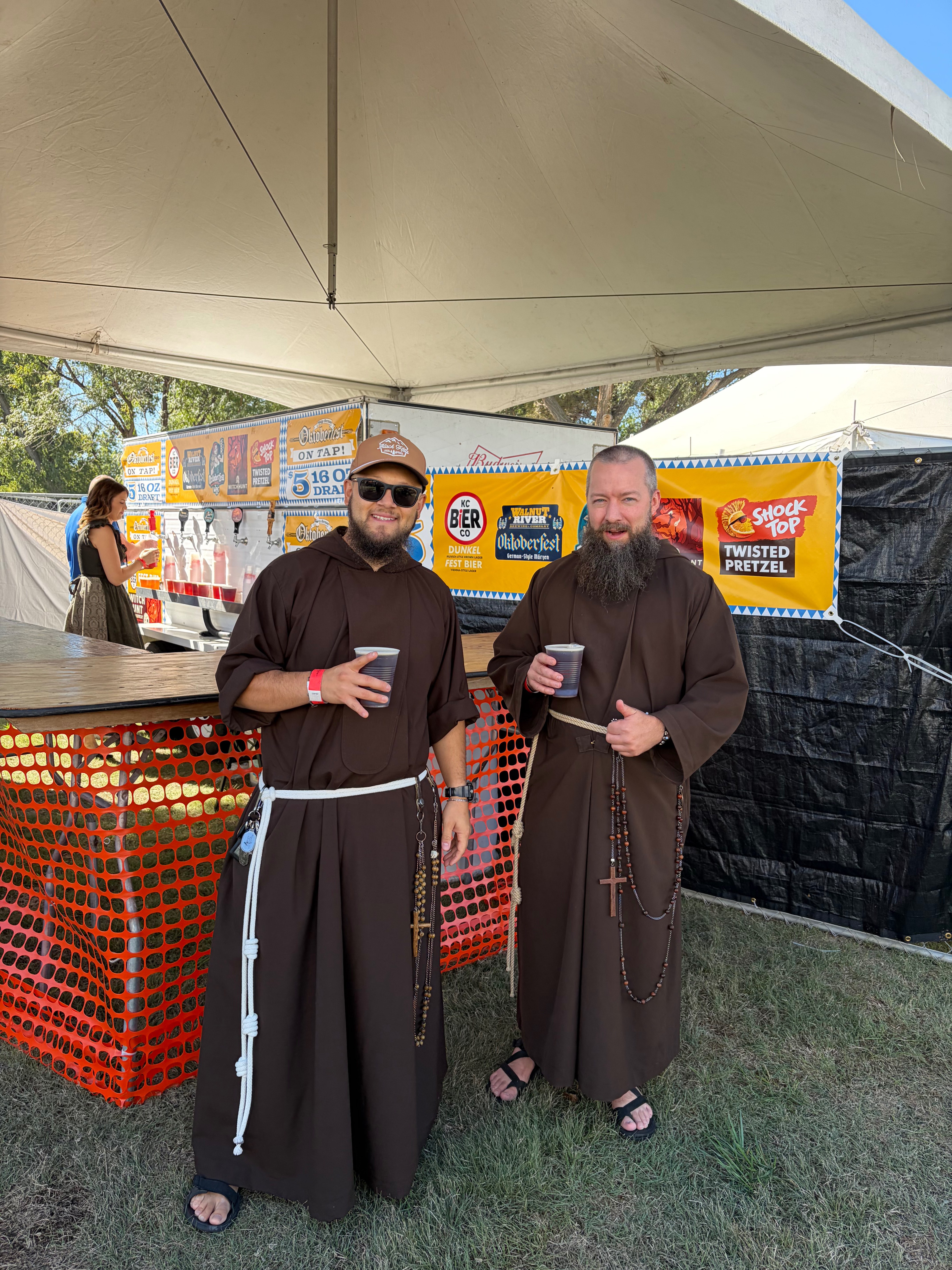 Two Oktoberfest goers pose for a picture while holding beer at Oktoberfest Hays 2026. Photo by Alin Hett/Hays Post&nbsp;