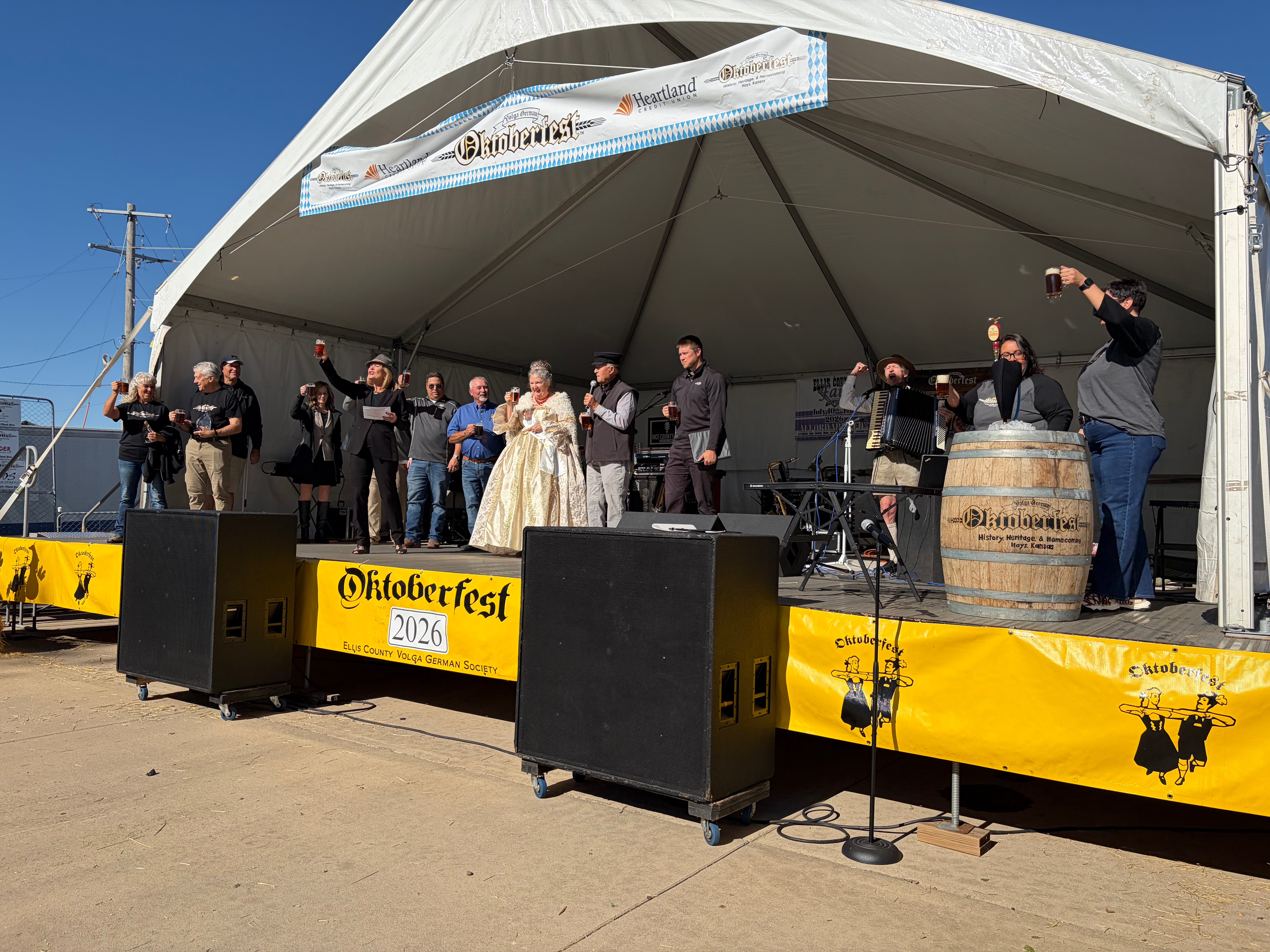 The Oktoberfest committee raises their glasses for everyone in attendance to cheers and give the green light to kick off Oktoberfest Hays 2026. Photo by Alin Hett/Hays Post.&nbsp;