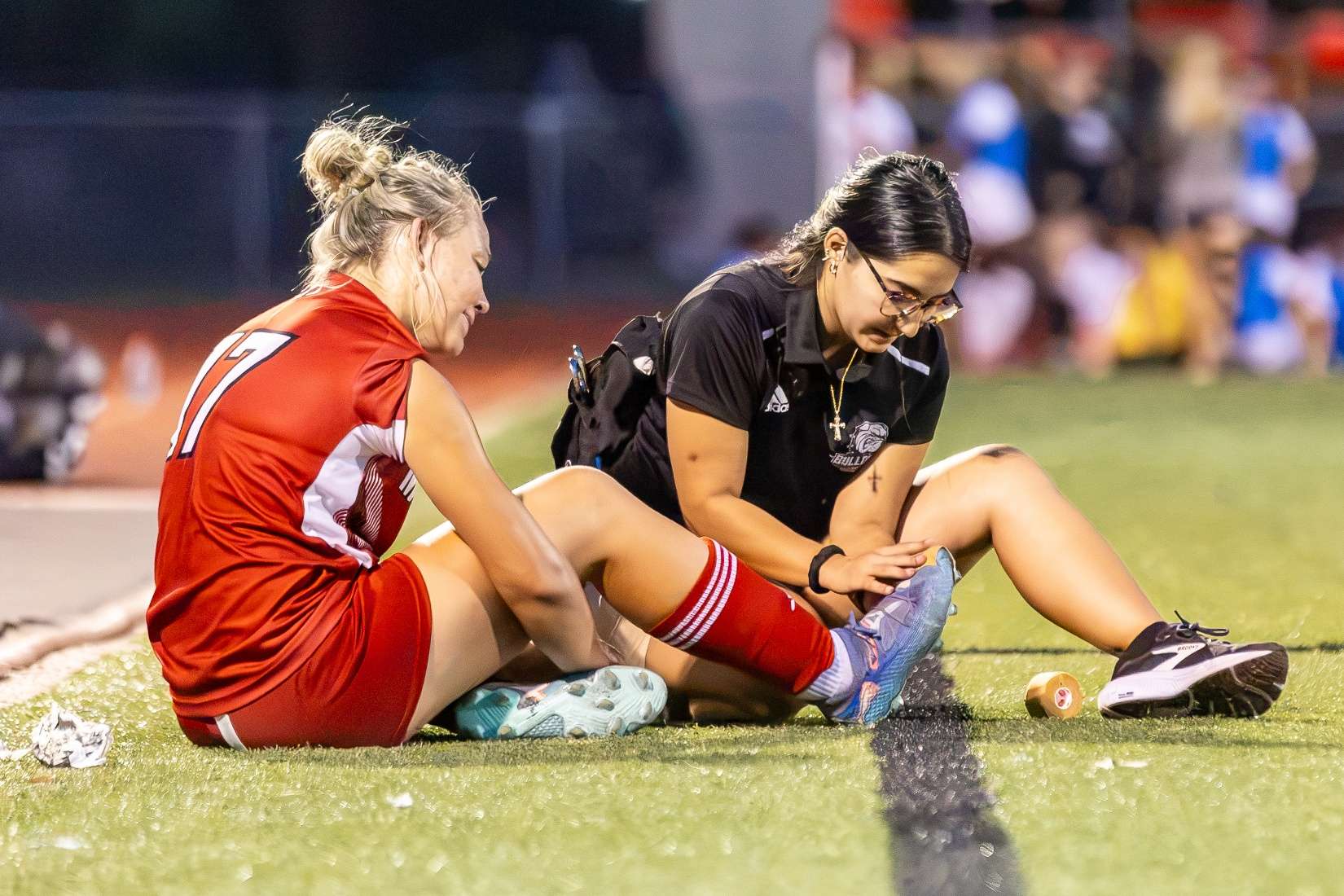 McPherson College athletic trainer works with a Bulldog soccer player. (Courtesy McPherson College).
