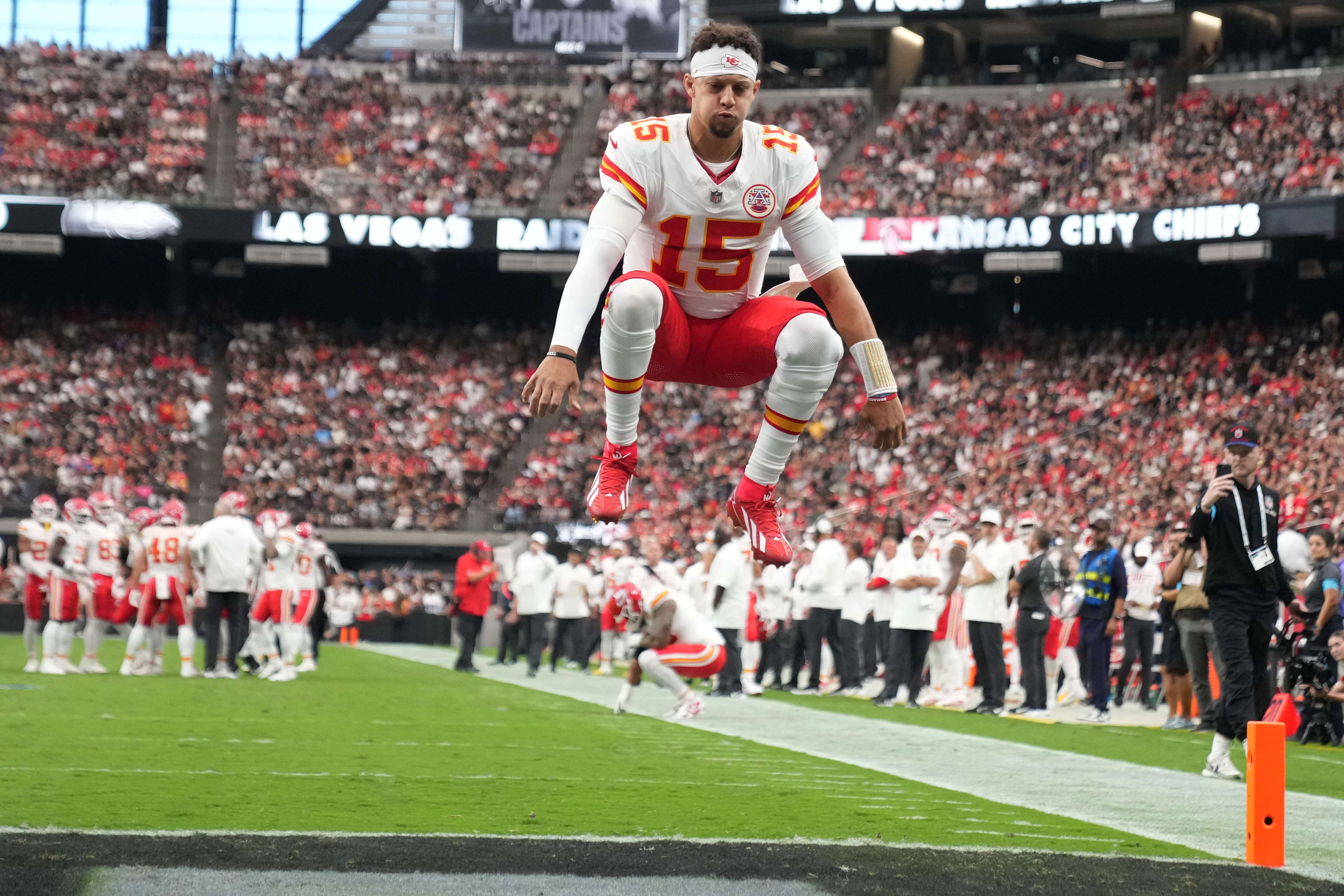 Kansas City Chiefs quarterback Patrick Mahomes (15) jumps into the air before an NFL football game against the Las Vegas Raiders in Las Vegas, Sunday, Oct. 4, 2026. (AP Photo/Rick Scuteri)